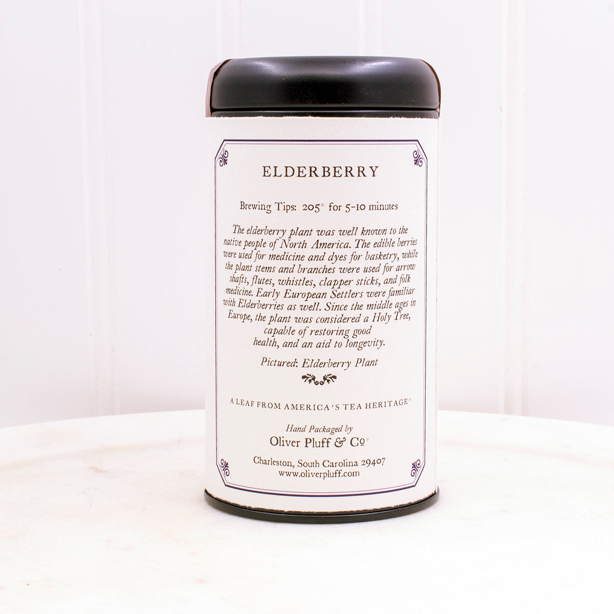 Elderberry Teabags Tea Tin featuring a matte black design with 20 pillow sachet teabags inside, showcasing natural ingredients.