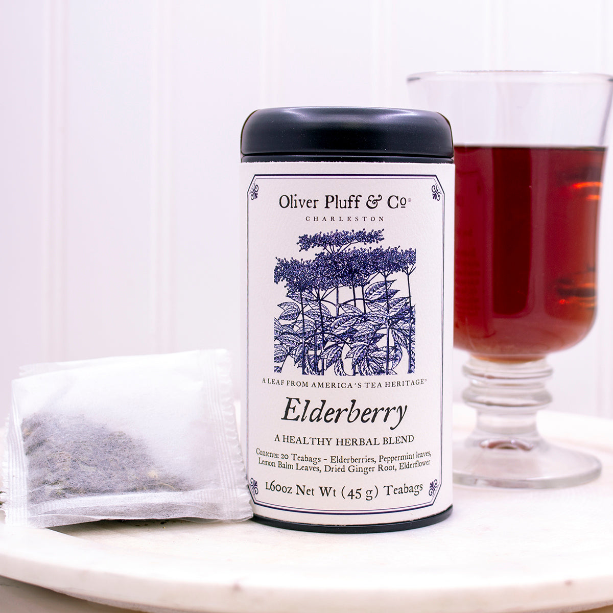 Elderberry Teabags Tea Tin featuring a matte black design with 20 pillow sachet teabags inside, showcasing natural ingredients.