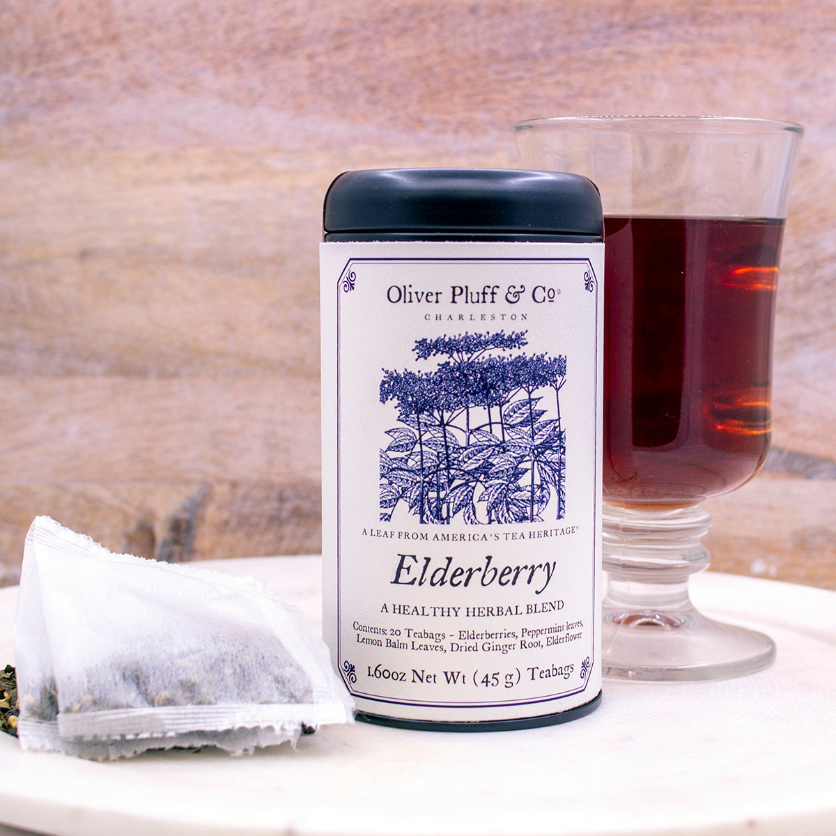 Elderberry Teabags Tea Tin featuring a matte black design with 20 pillow sachet teabags inside, showcasing natural ingredients.