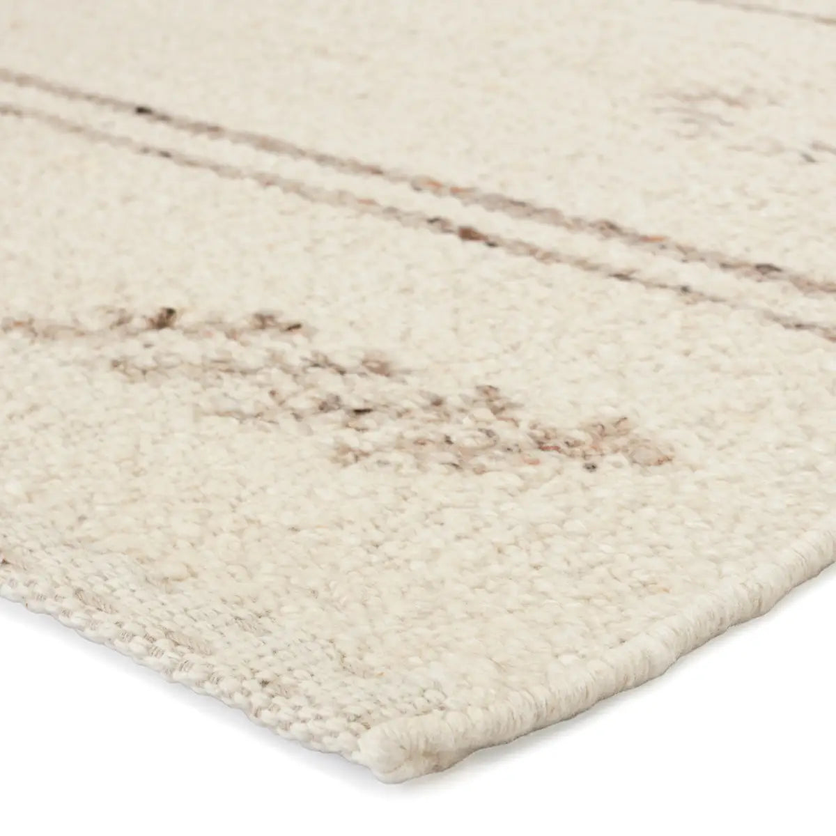 Handwoven Essek Rug featuring a light brown tribal pattern on a cream base, perfect for modern interiors.