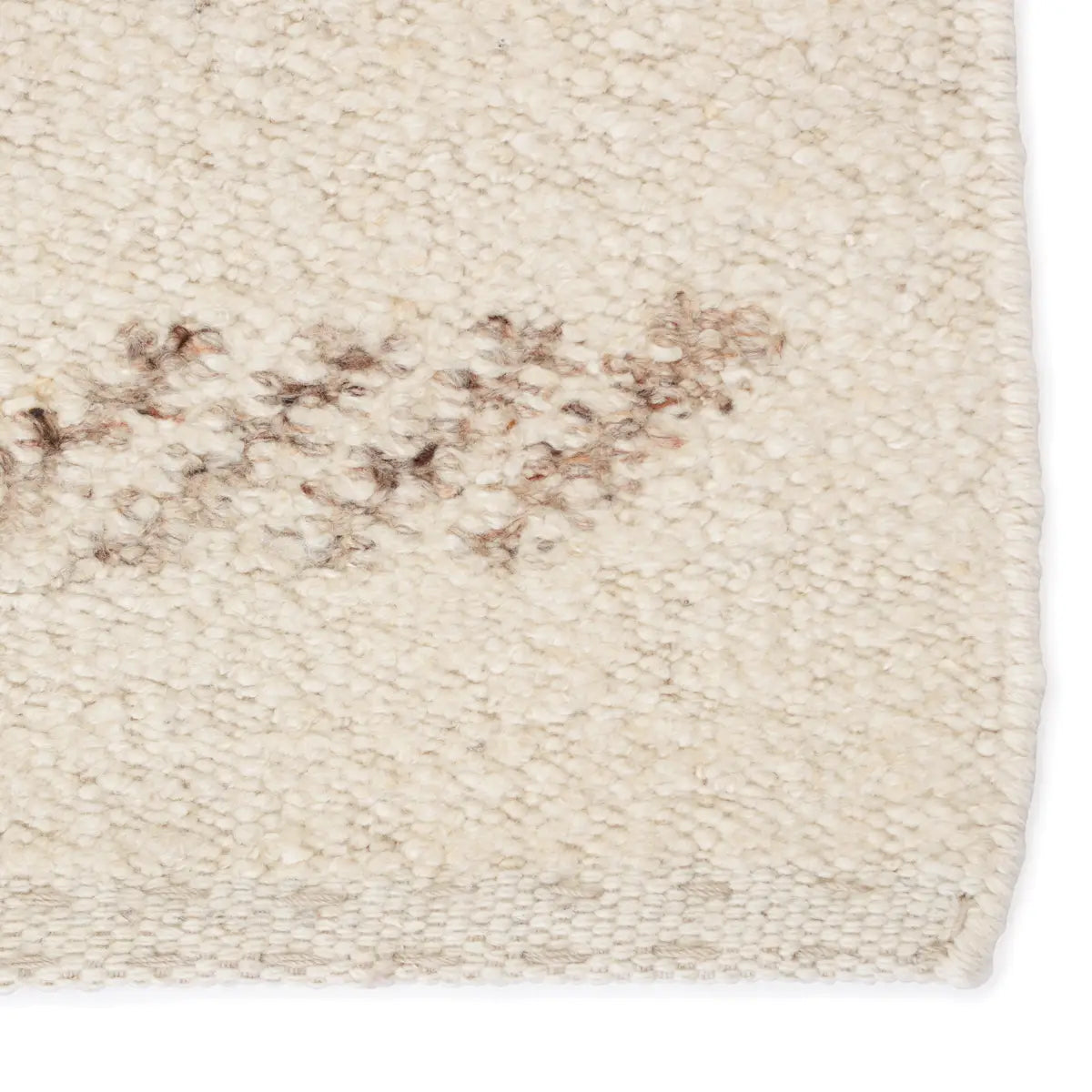 Handwoven Essek Rug featuring a light brown tribal pattern on a cream base, perfect for modern interiors.