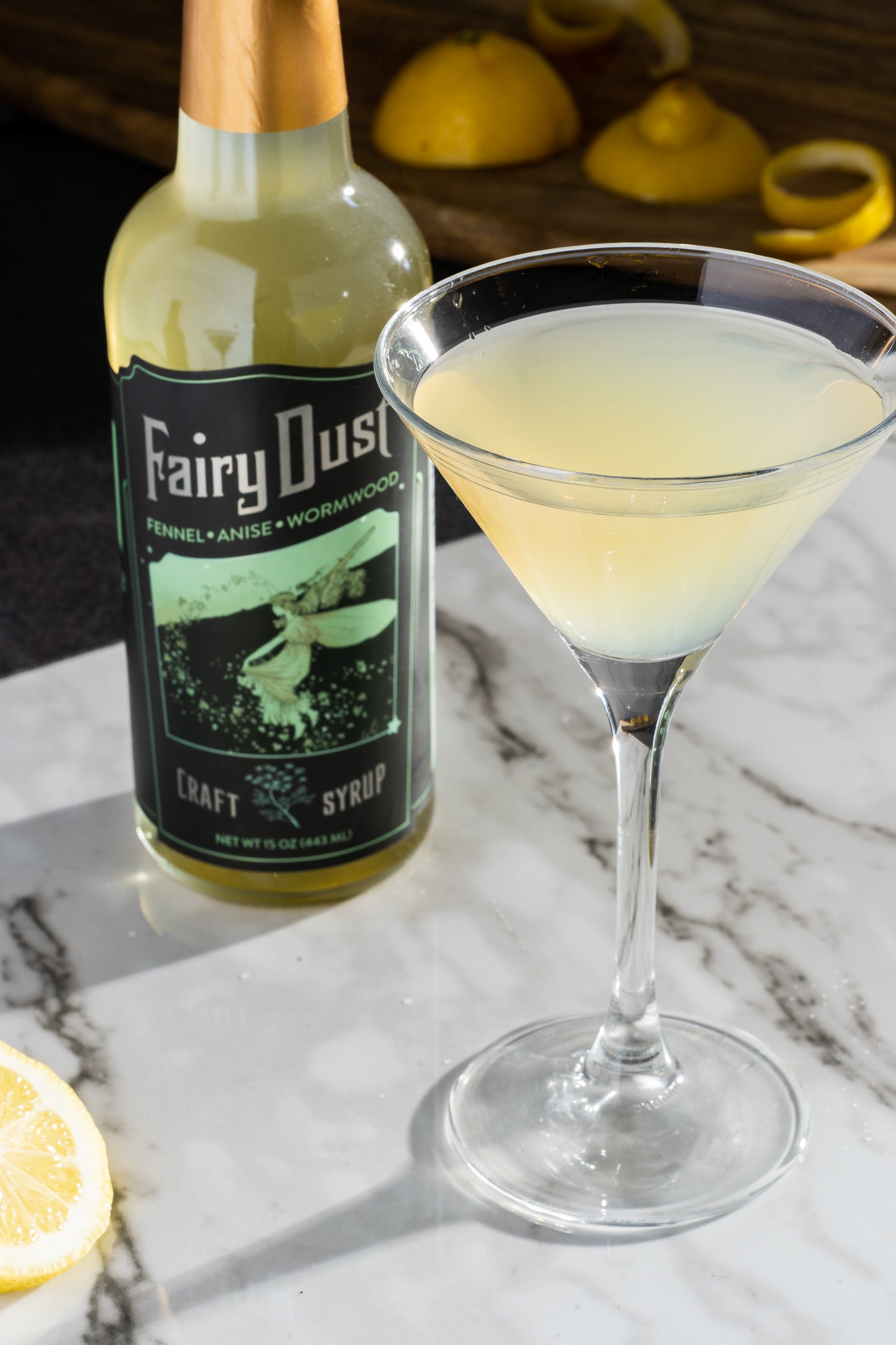 A bottle of Fairy Dust Syrup featuring a blend of fennel, anise, and wormwood, elegantly designed for cocktails and mocktails.