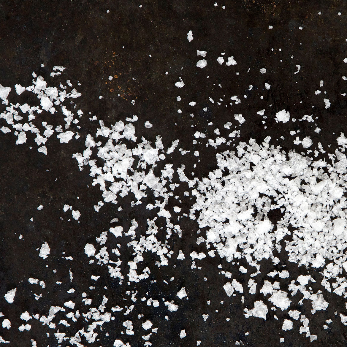 A close-up of Saltverk Flaky Sea Salt crystals, showcasing their unique flaky texture and natural mineral-rich appearance.