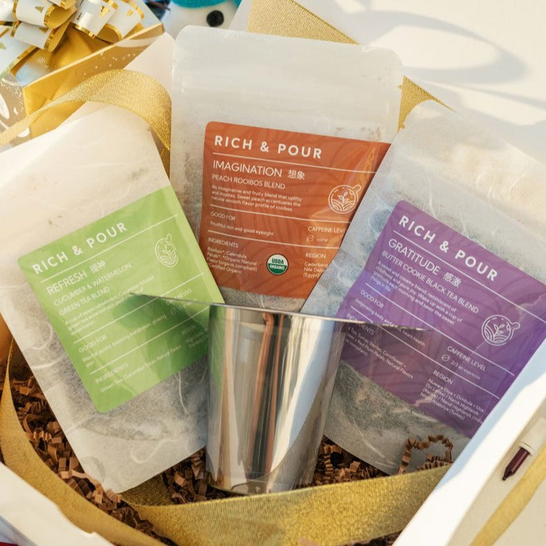 Flavored Looseleaf Gift Set featuring three tea blends and a stainless steel infuser, beautifully packaged for gifting.