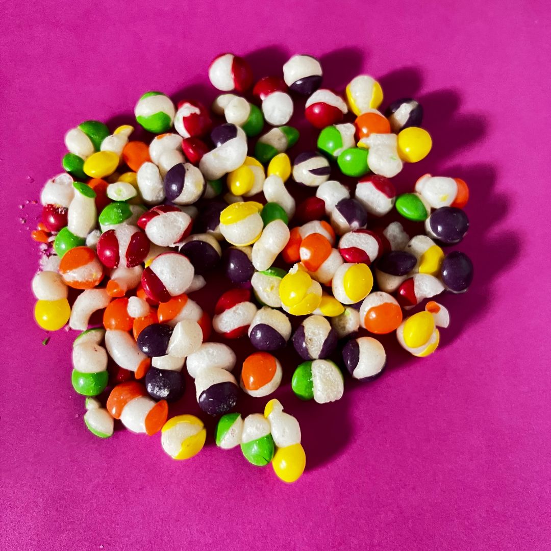 A colorful assortment of freeze dried Skittles in a 50g pack, showcasing their unique crunchy texture and vibrant fruity colors.