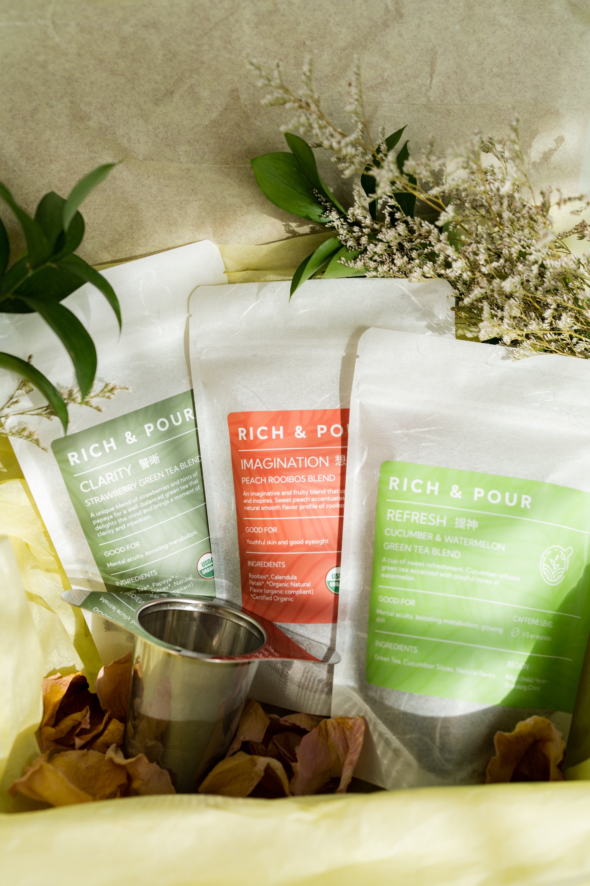 Fruity & Fresh Bundle featuring three fruit-infused tea blends and a stainless steel strainer, beautifully packaged.