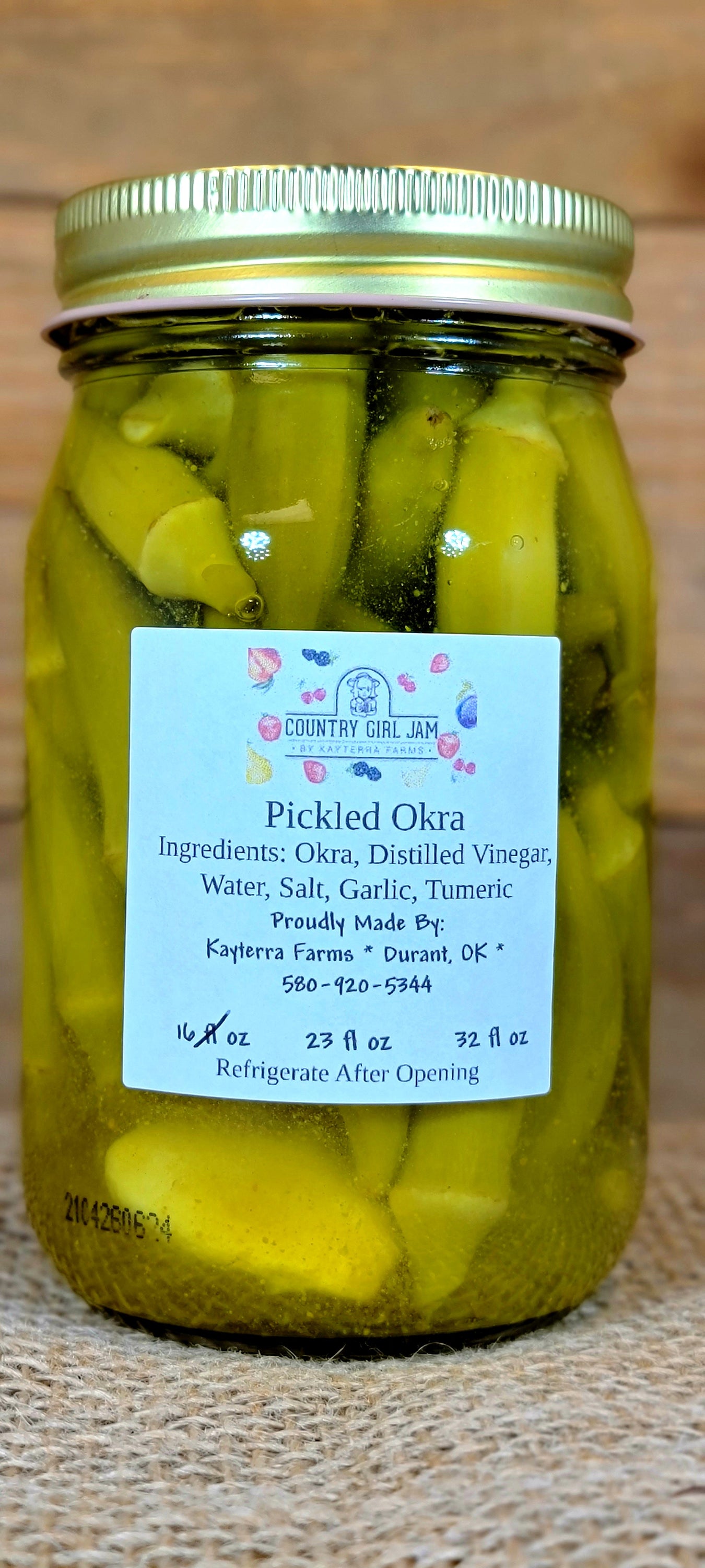 A jar of Garlic Pickled Okra showcasing vibrant green okra pods infused with garlic, perfect for snacking or adding to dishes.