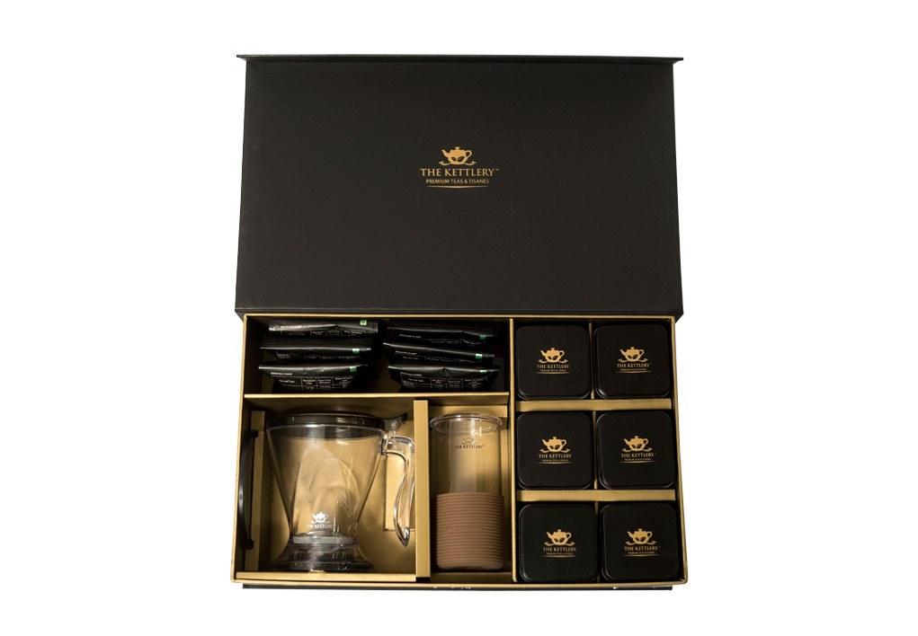 Elegant Gentlemen's Tea Set featuring premium loose leaf teas, a brew maker, iced tea glass, and storage tins, perfect for tea lovers.