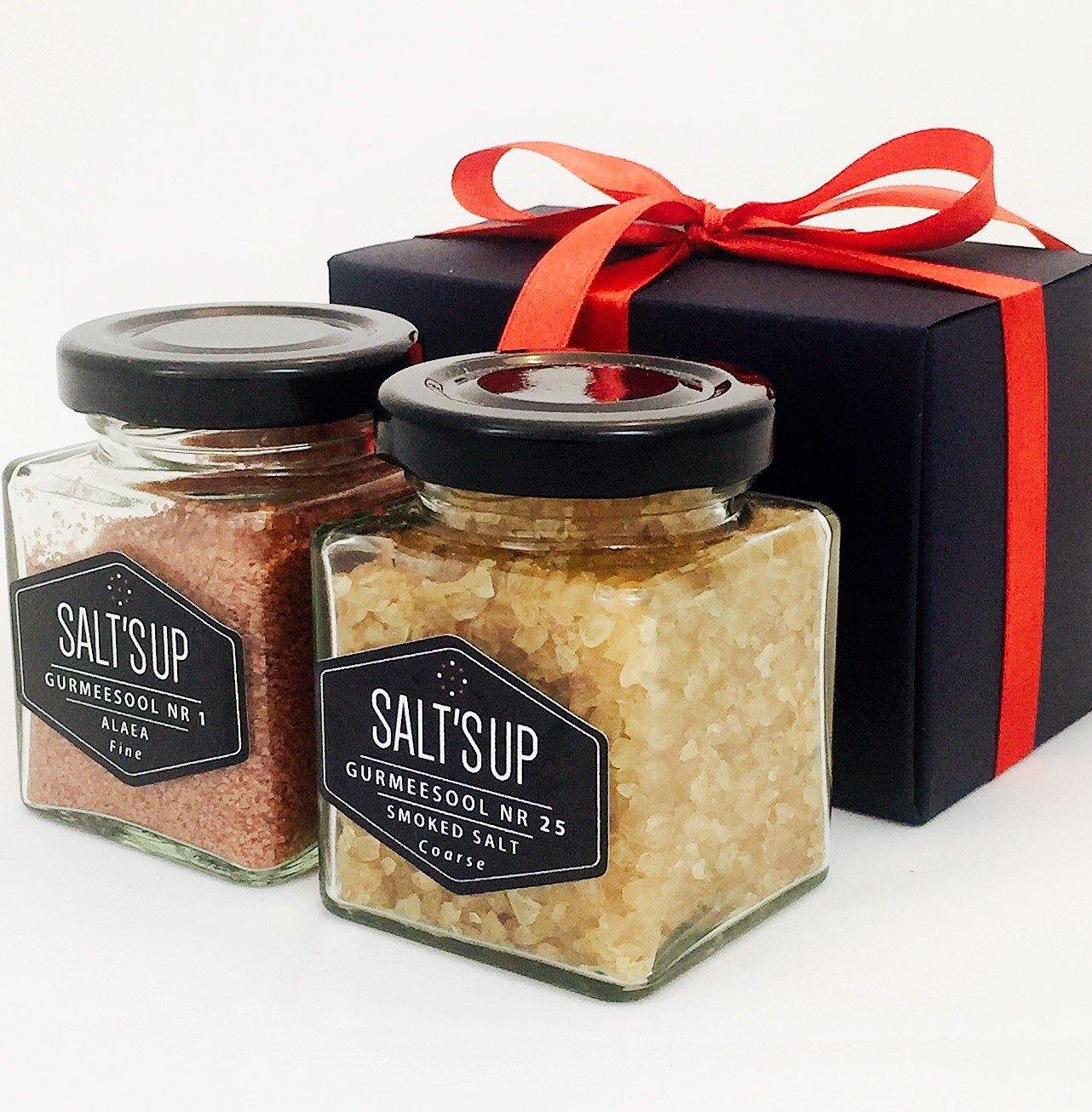 Gift box containing two gourmet salts: Hawaiian Alaea coarse salt and smoked coarse sea salt in elegant glass jars.