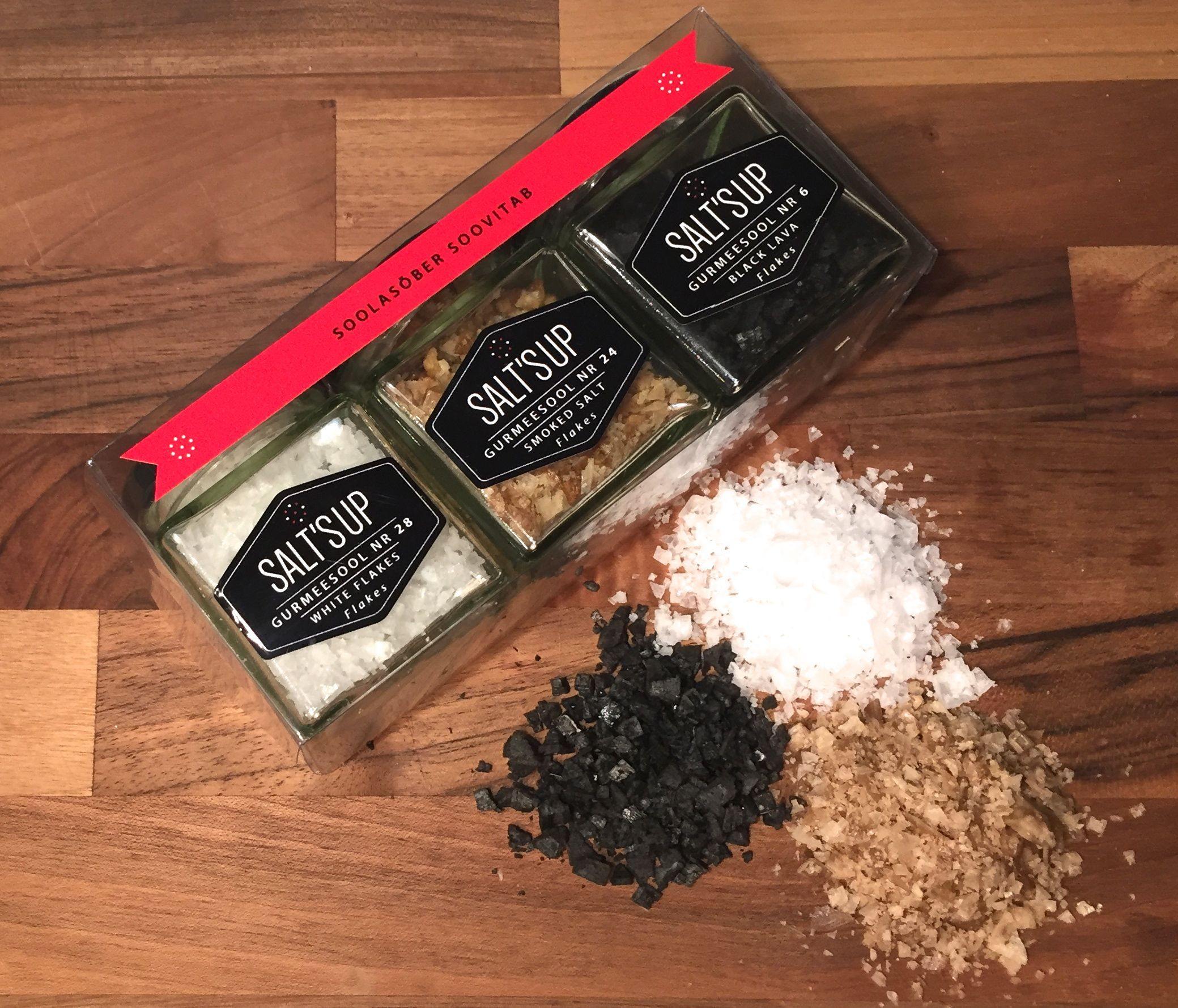 A beautifully arranged gift box containing three jars of gourmet salt flakes: Cyprus White, Smoked Salt, and Black Lava flakes, each with unique textures and flavors.