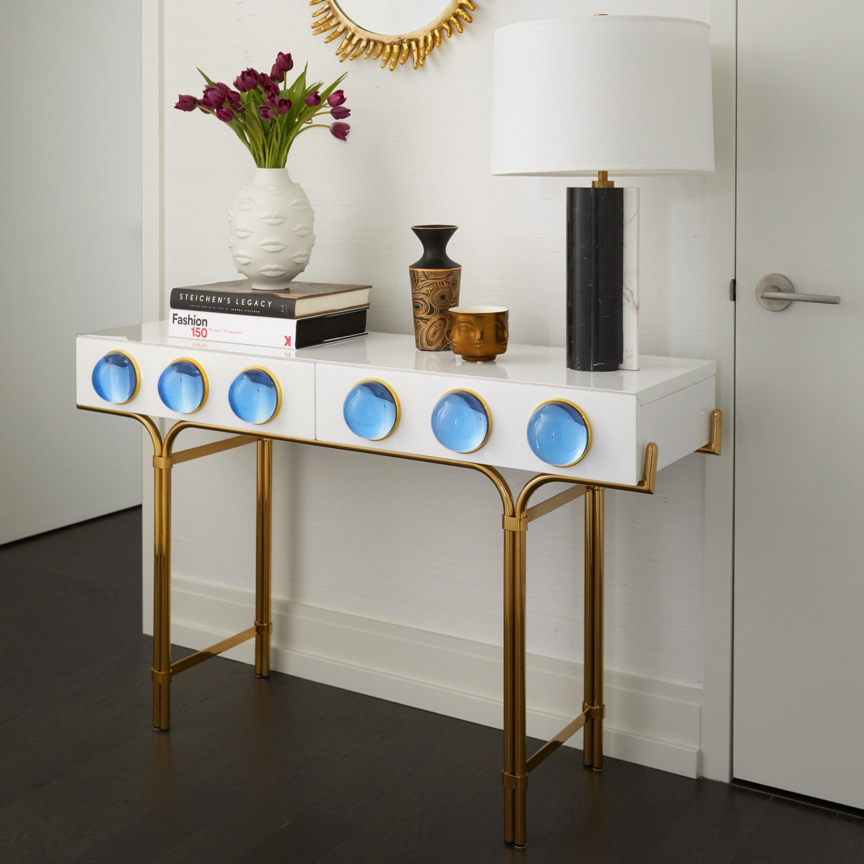 Globo Console featuring glossy white lacquer, brass framework, and blue acrylic cabochons.