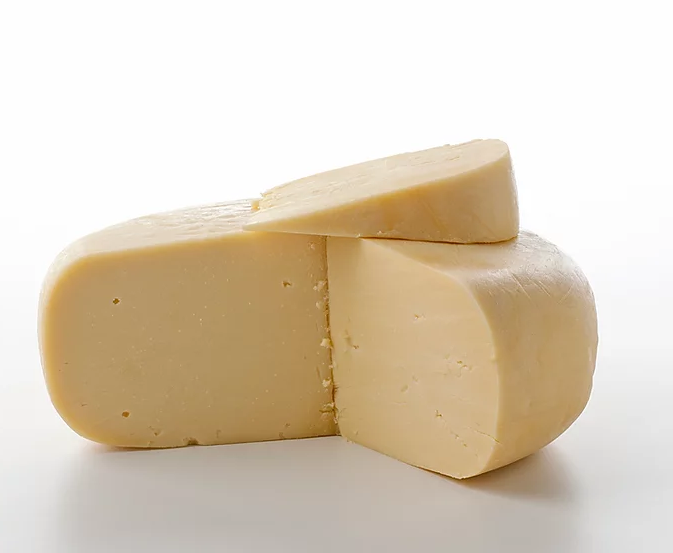 A block of creamy Gouda cheese with a smooth texture, showcasing its rich yellow color, perfect for cheese boards and culinary dishes.