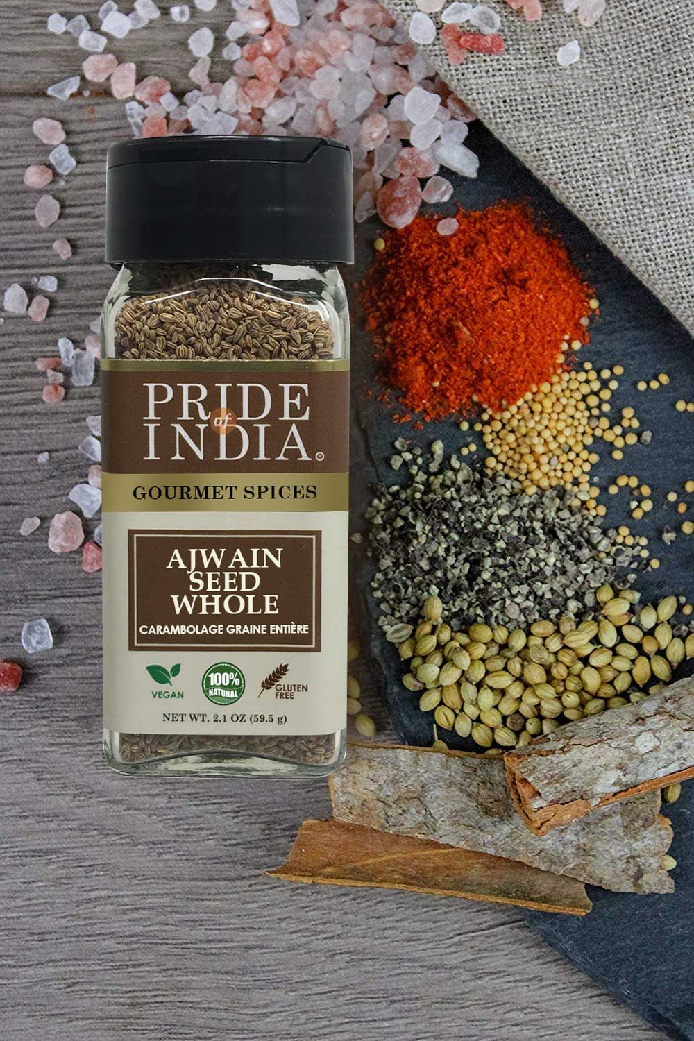 A jar of Gourmet Ajwain Seed Whole by Pride of India, showcasing brown carom seeds with a dual sifter cap for easy dispensing.