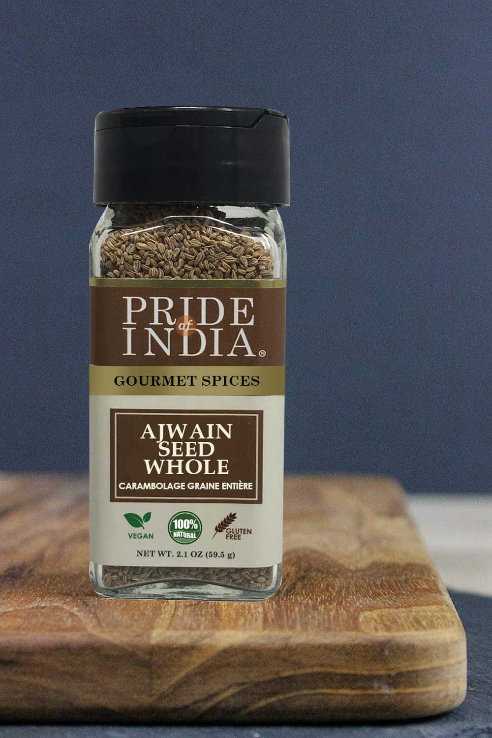 A jar of Gourmet Ajwain Seed Whole by Pride of India, showcasing brown carom seeds with a dual sifter cap for easy dispensing.