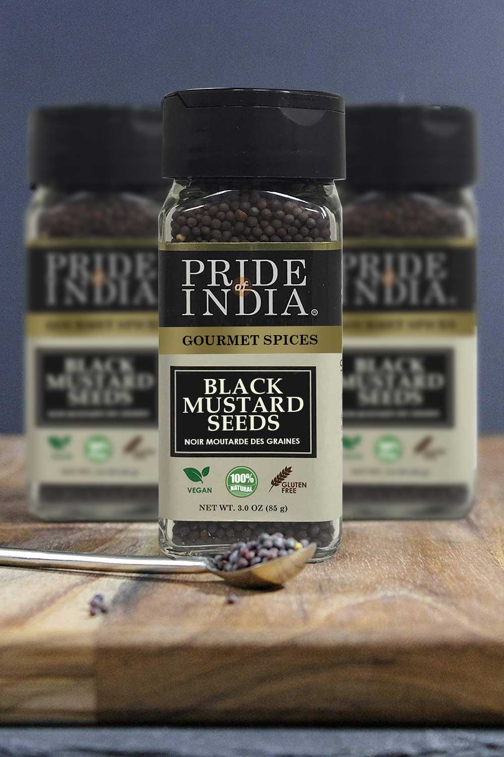 A close-up of Gourmet Black Mustard Seed Whole, showcasing round black-brown seeds in a rustic wooden bowl, emphasizing their rich texture and quality.