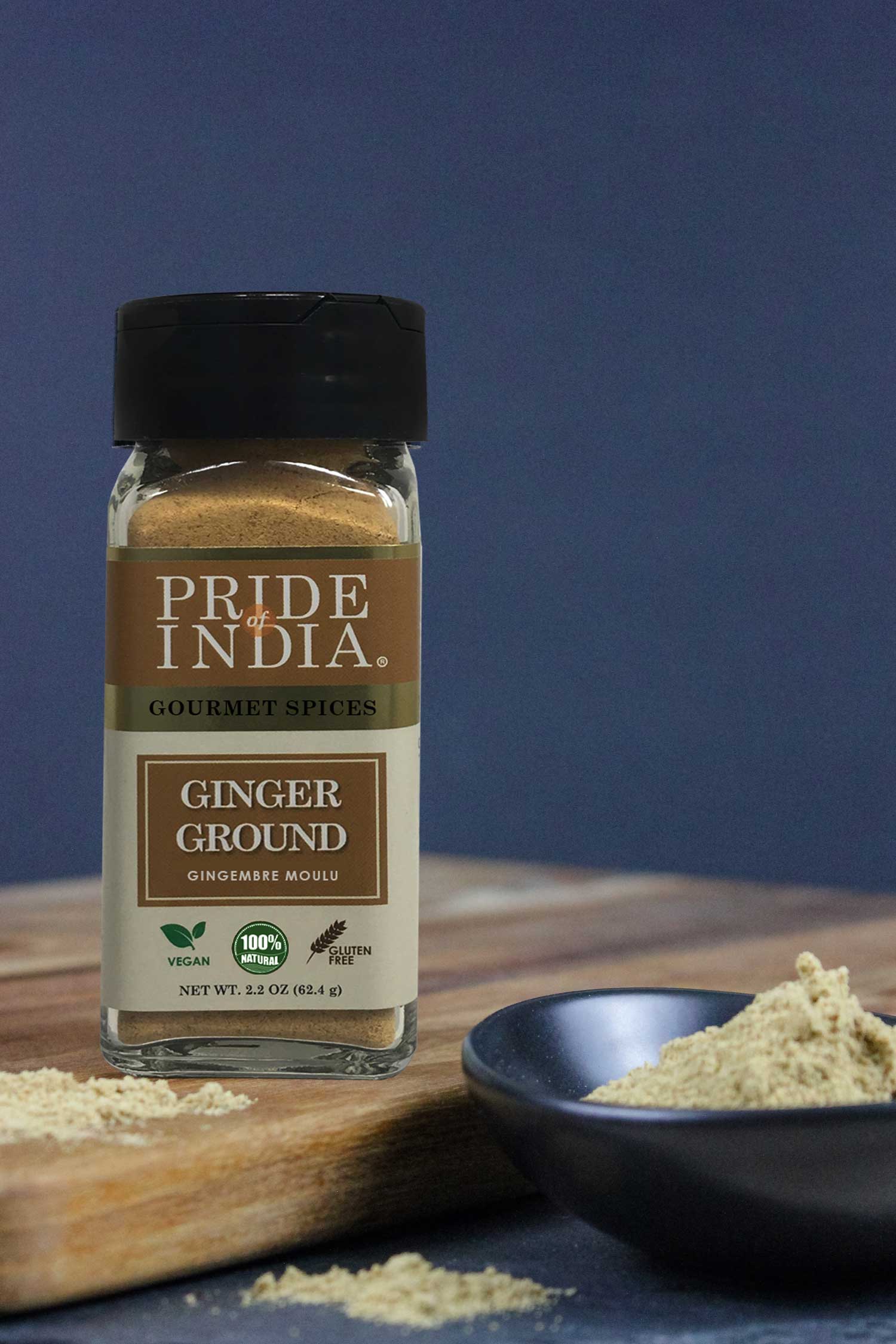 A jar of Pride of India Gourmet Ginger Fine Ground showcasing its fine texture and rich yellow color, perfect for enhancing dishes.