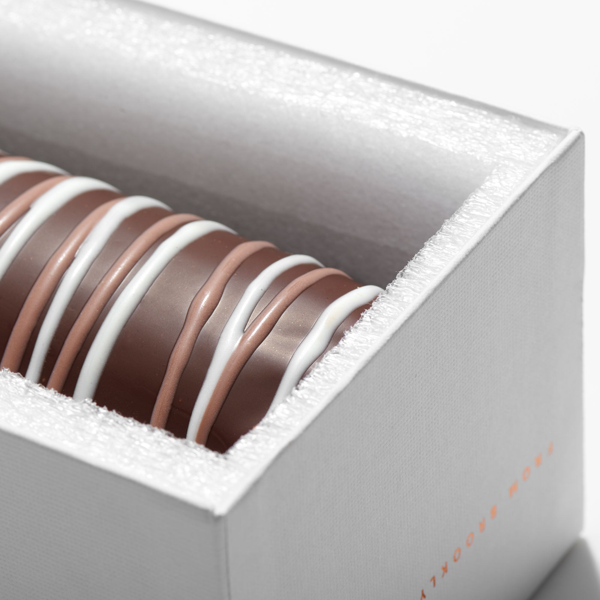 Gourmet Truffle Log In Gift Box featuring rich hazelnut ganache and dark chocolate coating, elegantly presented for gifting.