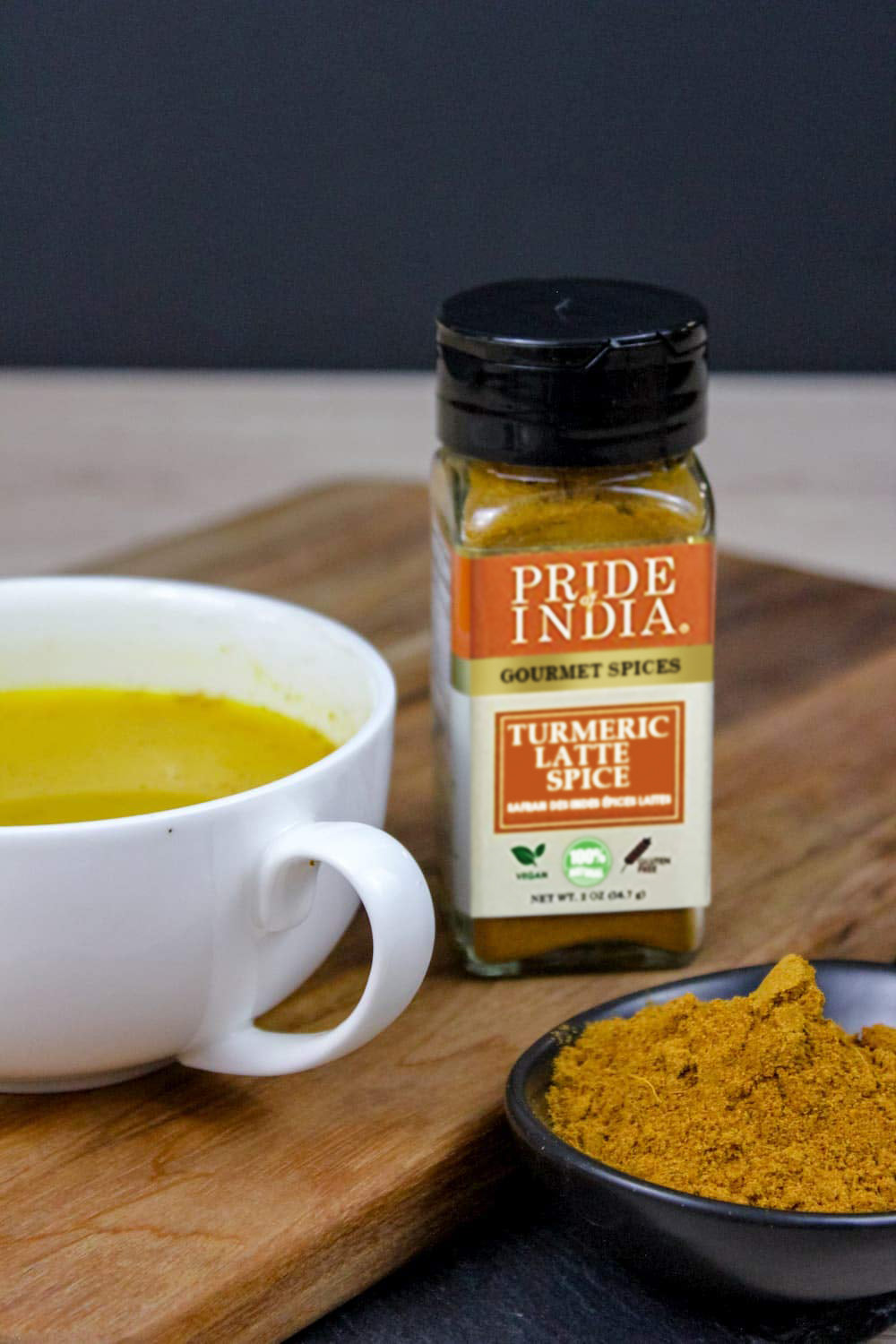 A vibrant jar of Gourmet Turmeric Latte Tea Spice Mix showcasing the blend of spices including turmeric, cinnamon, and ginger.