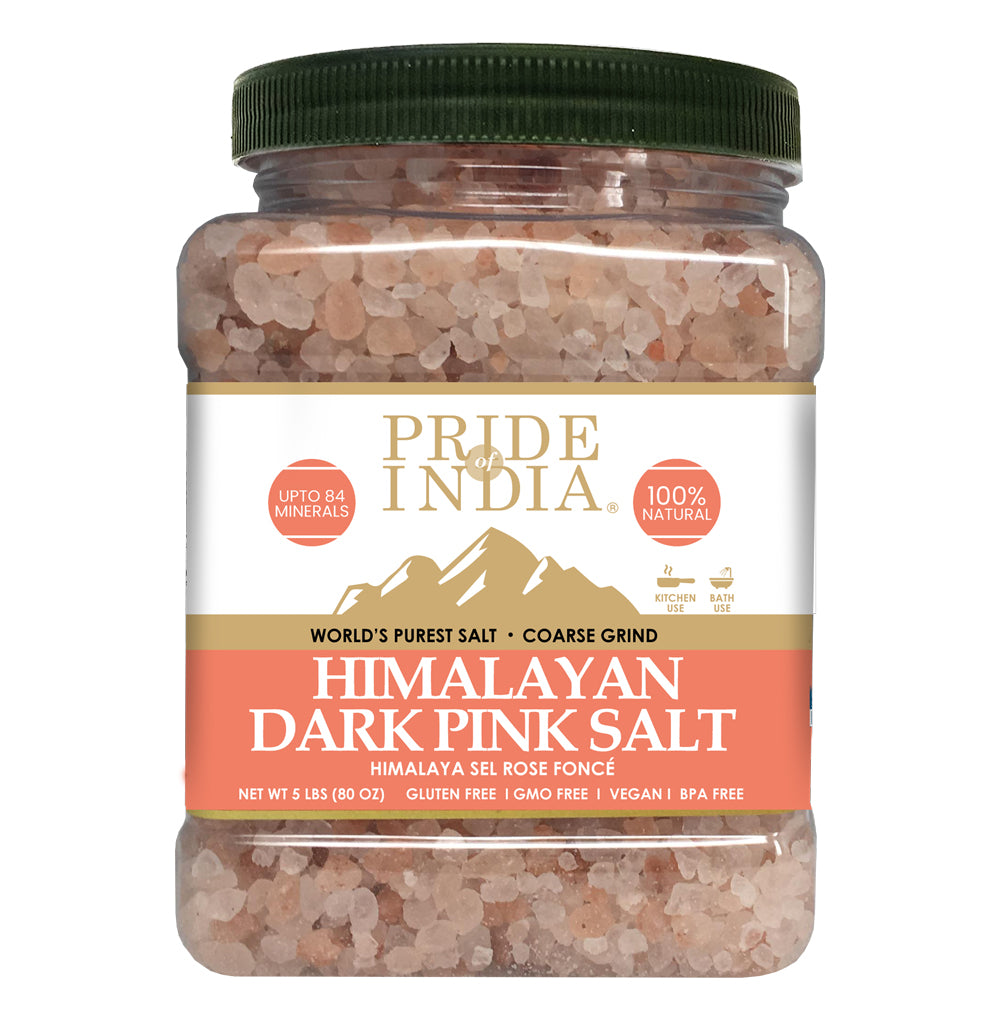 Coarse grind Himalayan pink rock salt in a wooden bowl, showcasing its natural reddish-pink color and texture.