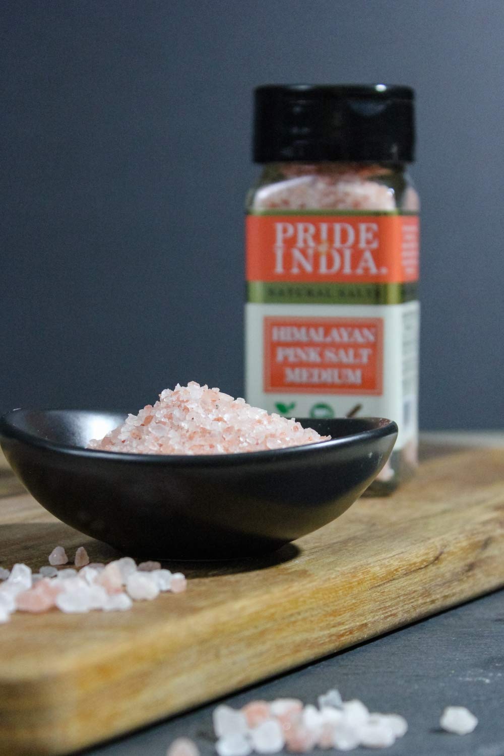 Small dual sifter jar filled with coarse Himalayan pink rock salt, showcasing its reddish-pink color and natural texture.