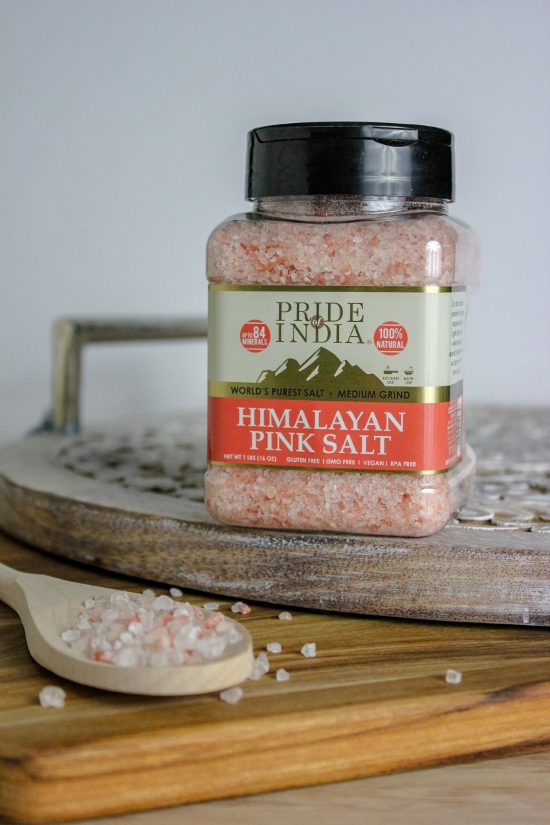 A bowl of Himalayan Pink Rock Salt - Medium Grind showcasing its coarse texture and reddish-pink color, ideal for cooking and therapeutic uses.