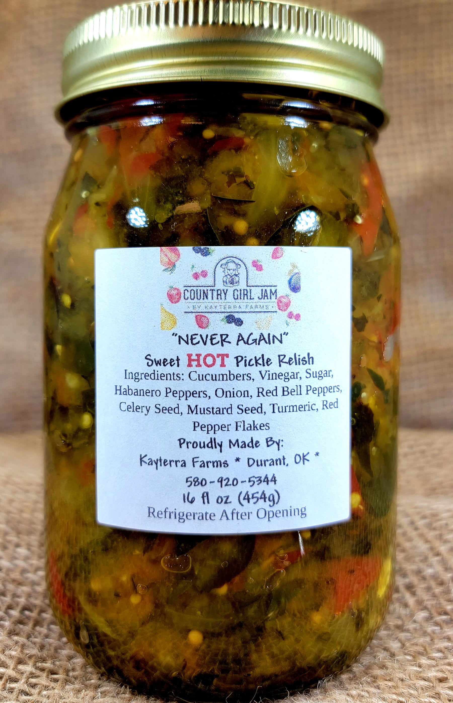 A jar of Hot Sweet Never Again Pickle Relish showcasing its vibrant color and spicy ingredients, perfect for enhancing meals.