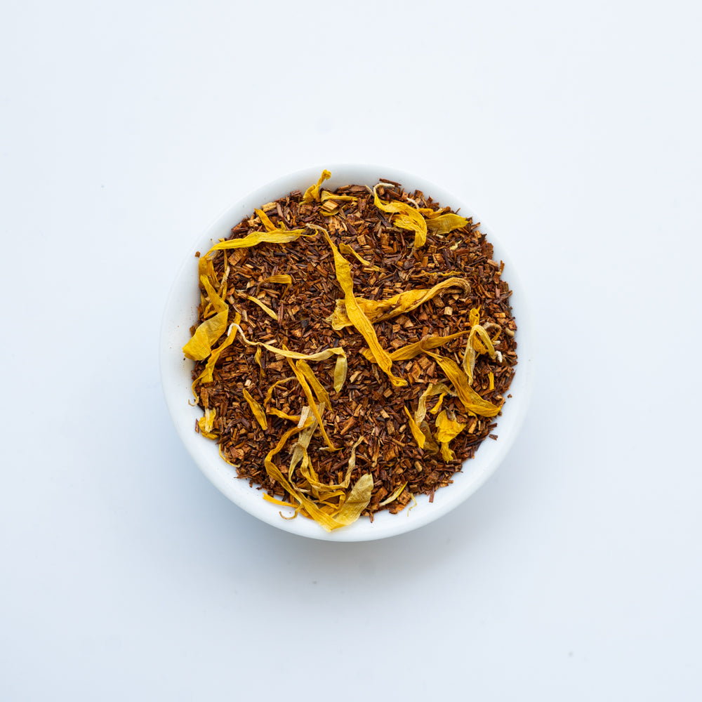 A vibrant package of Imagination Peach Rooibos Blend tea, showcasing its organic ingredients and fruity flavor profile.