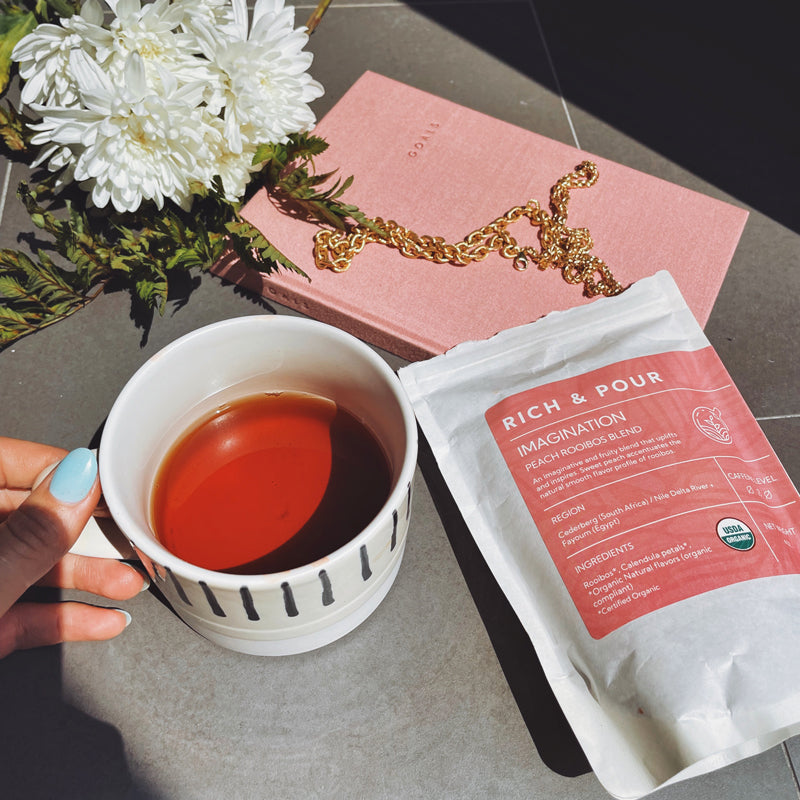 A vibrant package of Imagination Peach Rooibos Blend tea, showcasing its organic ingredients and fruity flavor profile.