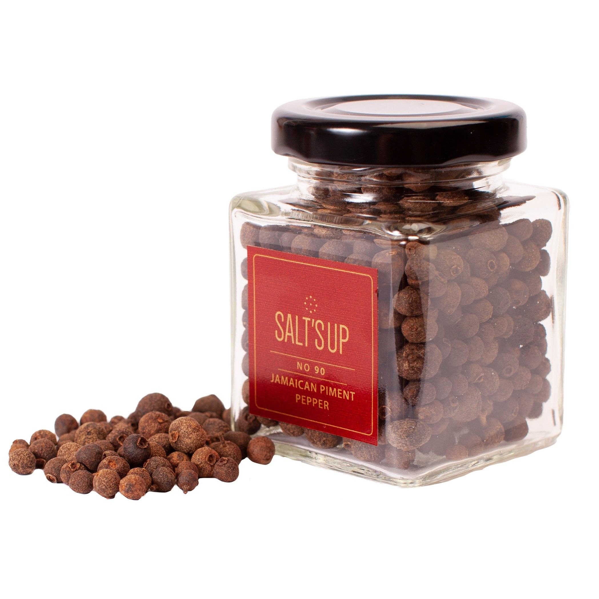 A glass jar containing 30g of Jamaican Piment pepper, showcasing its rich brown color and aromatic qualities.