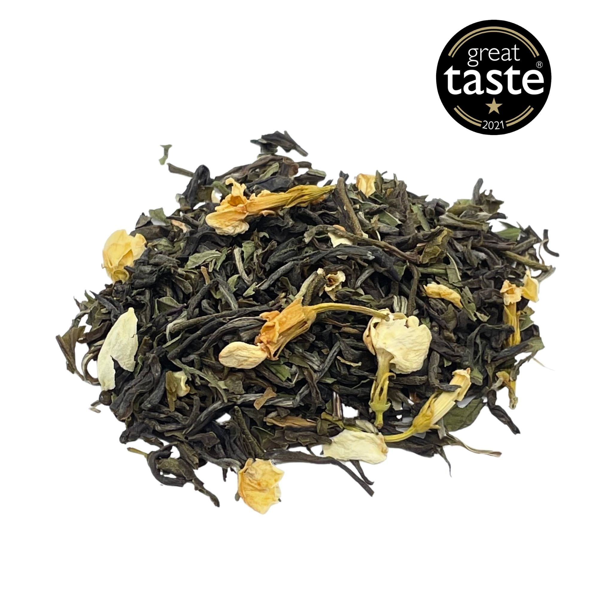 A vibrant display of Jasmine & Mint Green Tea loose leaf, showcasing green tea leaves, jasmine blossoms, and peppermint leaves.