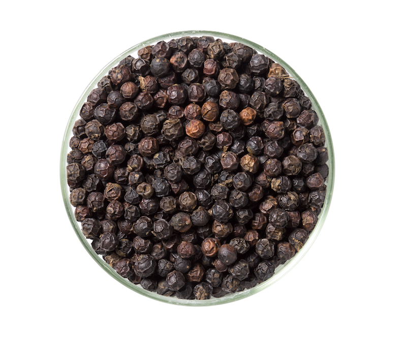 A close-up of KAMPOT BLACK pepper ecopack showcasing the rich black peppercorns and eco-friendly packaging.