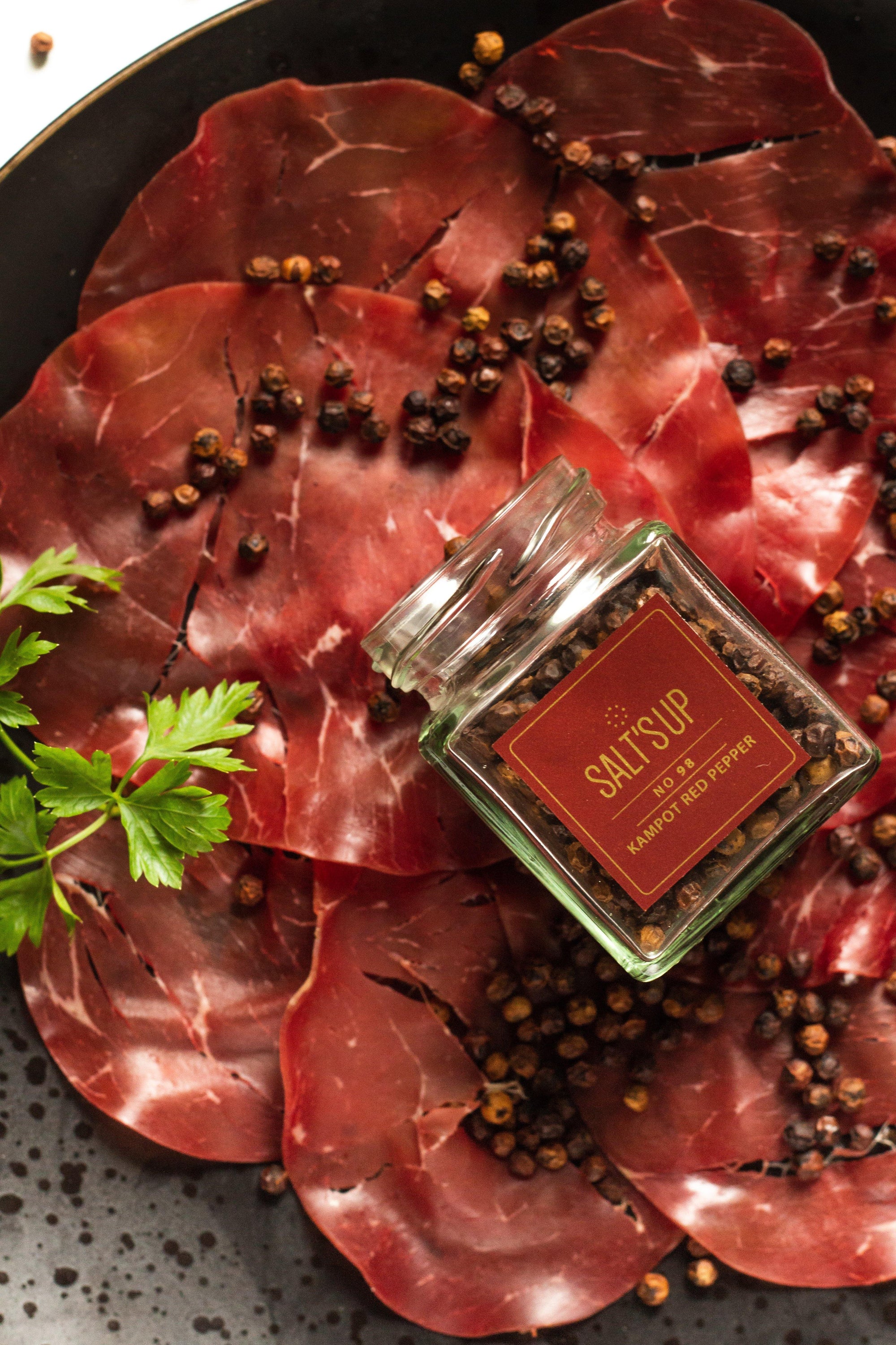 Kampot Red pepper ecopack showcasing the vibrant red peppercorns in eco-friendly packaging.