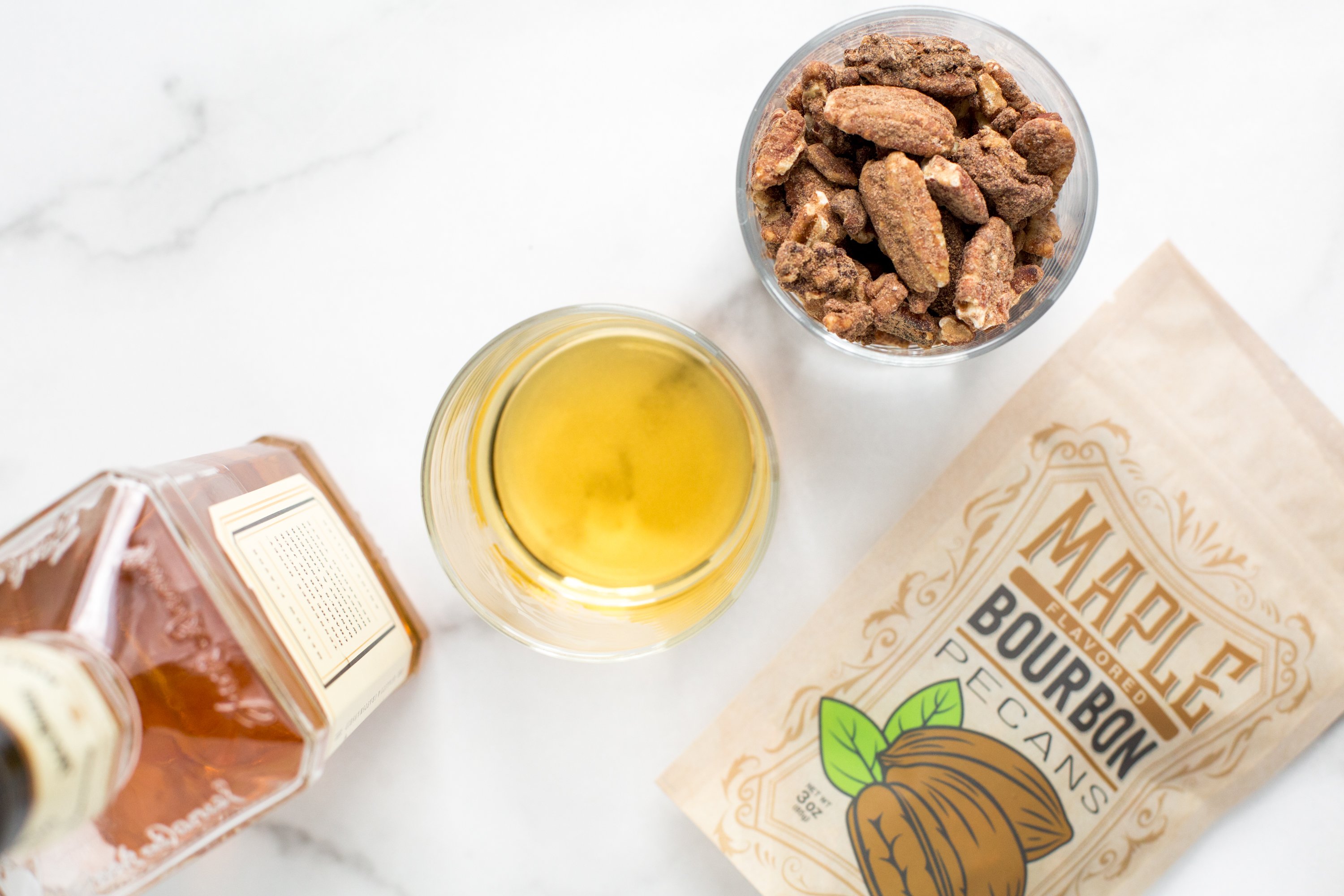 Five bags of Kettle-Cooked Maple Bourbon Pecans, showcasing their crunchy texture and rich flavor.