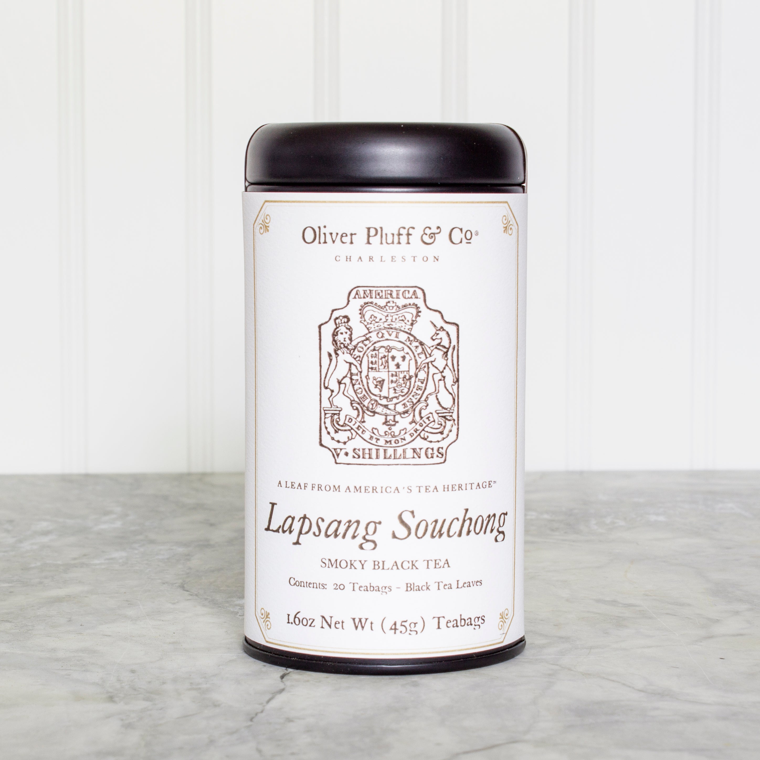 A stylish matte black tea tin containing Lapsang Souchong teabags, showcasing its elegant design and eco-friendly packaging.