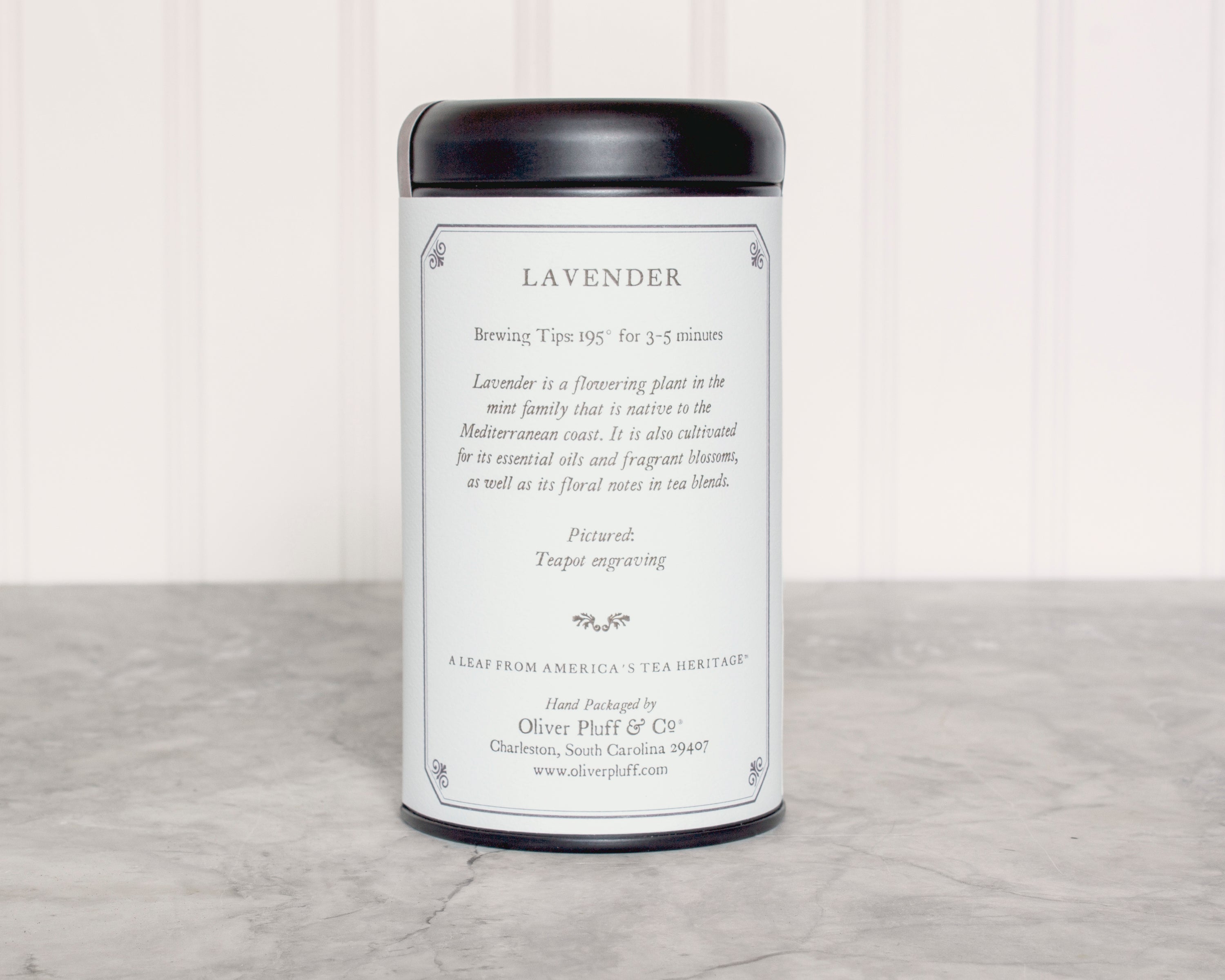 Lavender Teabags Tea Tin featuring 20 pillow sachets of aromatic black tea blended with lavender blossoms, elegantly packaged in a matte black tin.