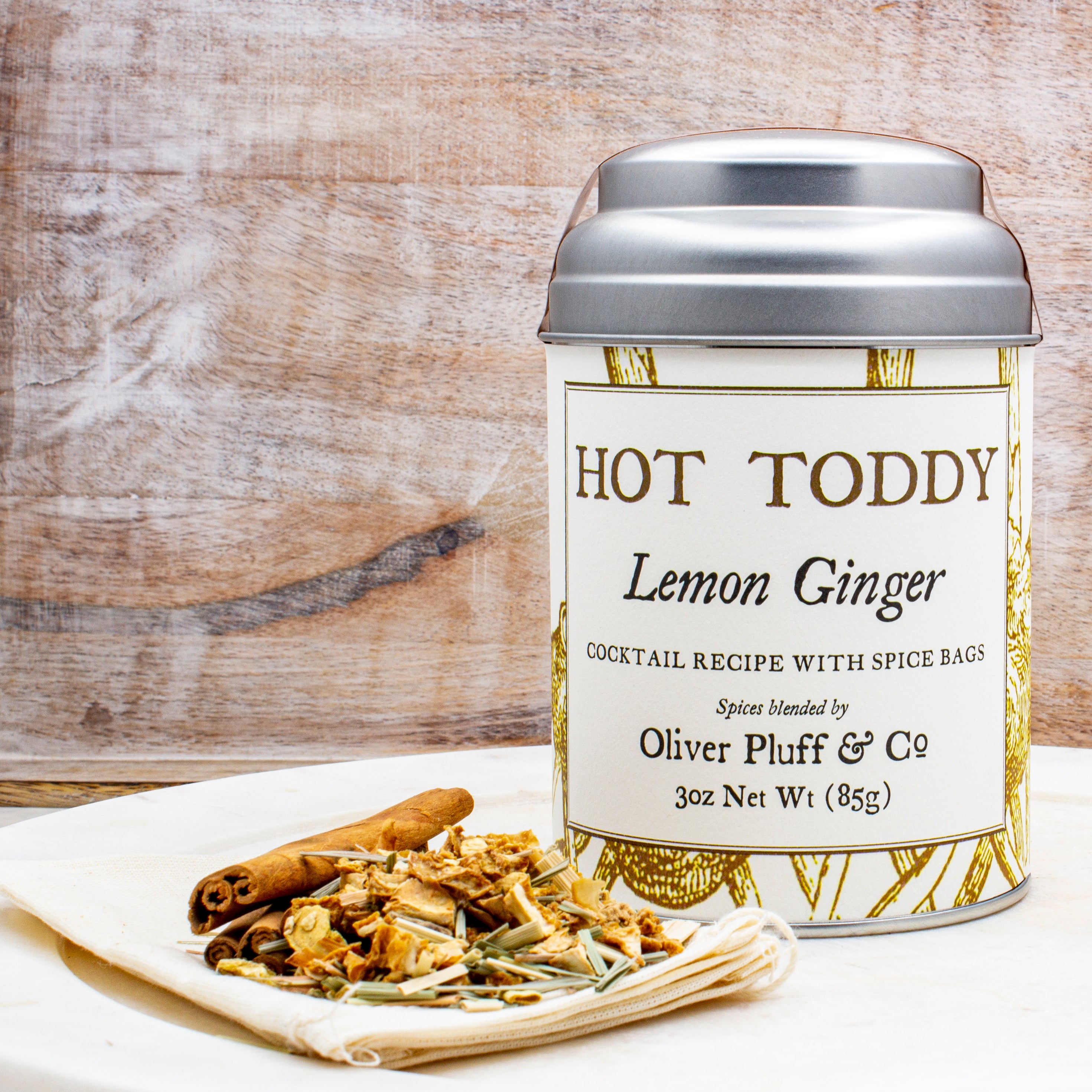 Lemon Ginger Hot Toddy Kit featuring muslin spice bags, cinnamon sticks, and dried lemon and ginger ingredients.