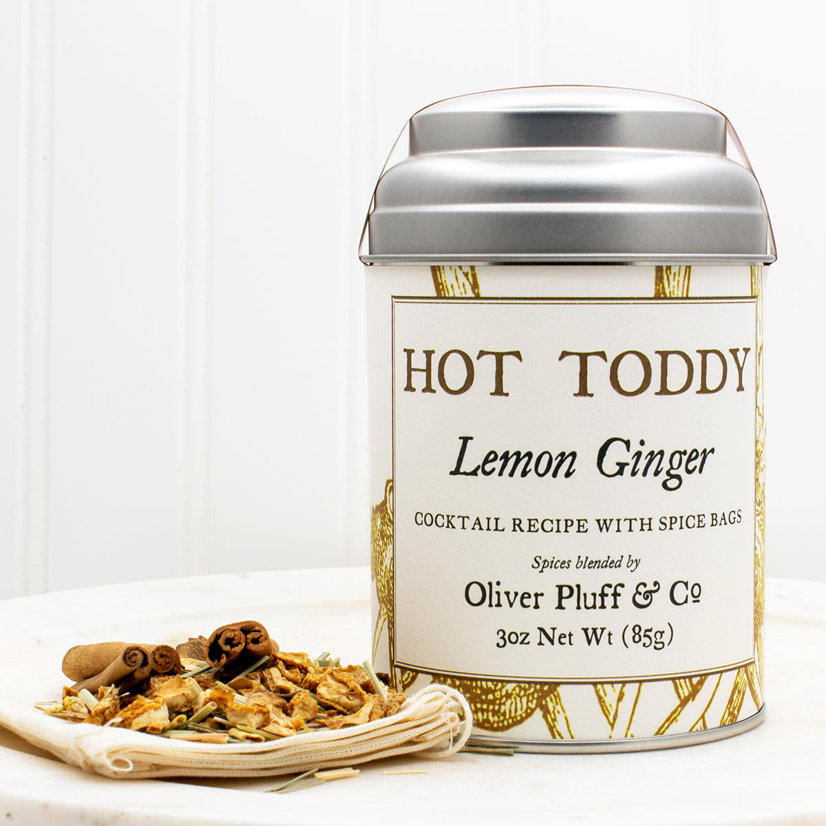 Lemon Ginger Hot Toddy Kit featuring muslin spice bags, cinnamon sticks, and dried lemon and ginger ingredients.