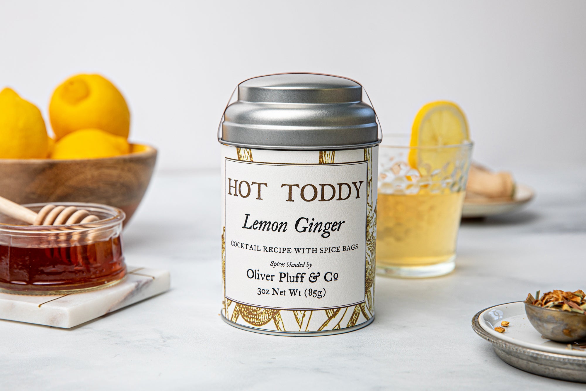 Lemon Ginger Hot Toddy Kit featuring muslin spice bags, cinnamon sticks, and dried lemon and ginger ingredients.