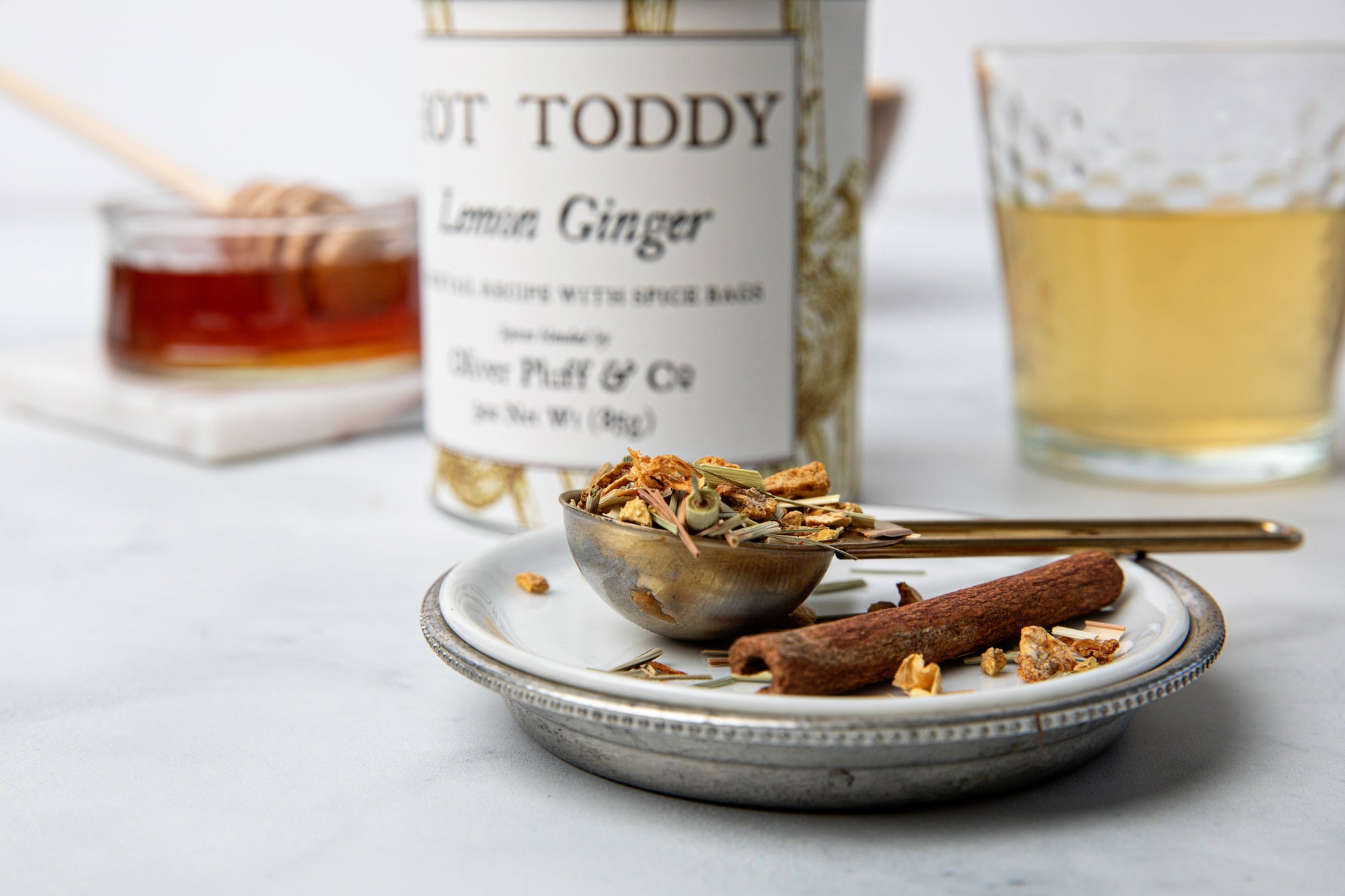 Lemon Ginger Hot Toddy Kit featuring muslin spice bags, cinnamon sticks, and dried lemon and ginger ingredients.