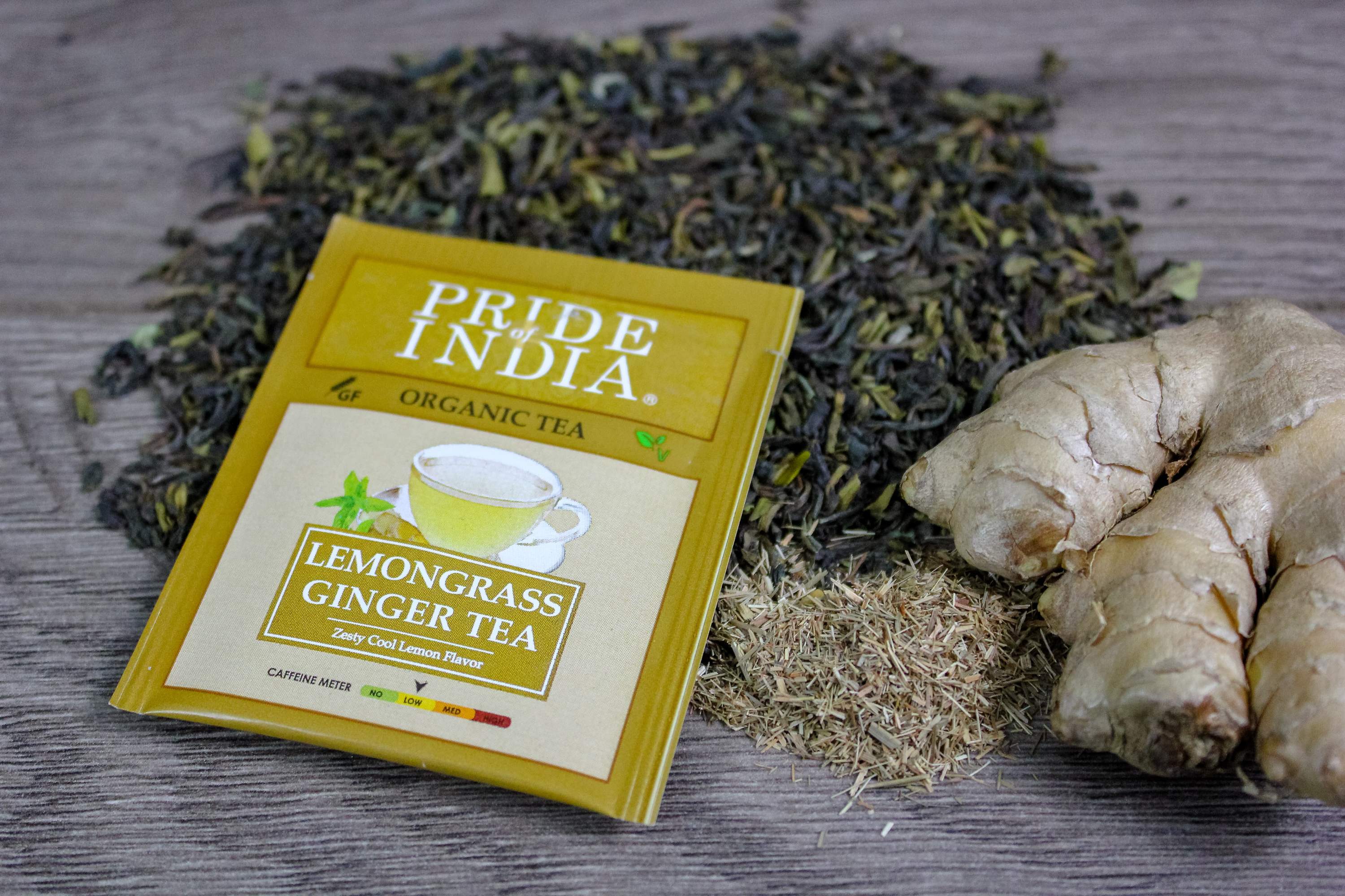 A box of Lemongrass Ginger tea bags featuring organic ingredients, showcasing the vibrant packaging and tea bags inside.