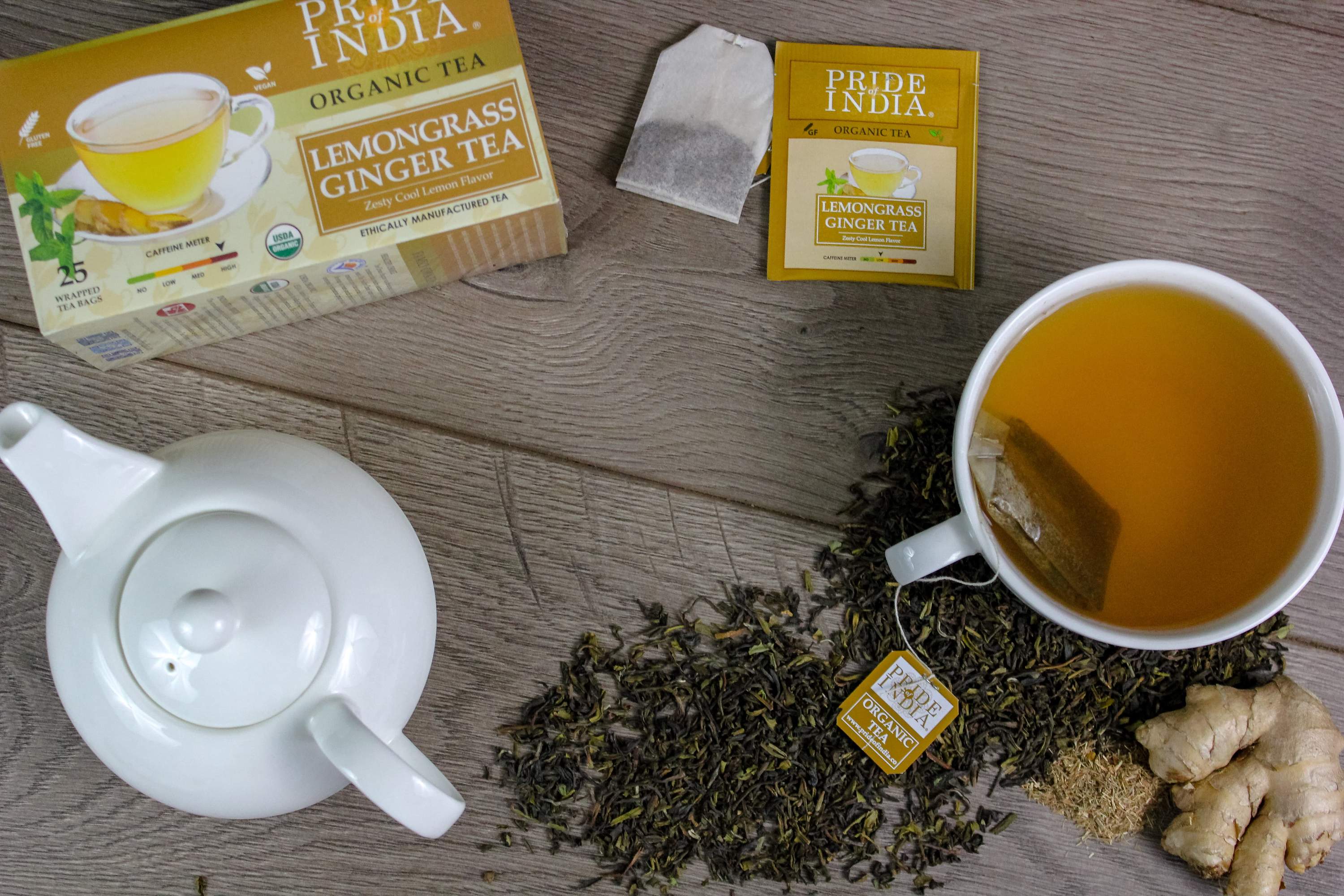 A box of Lemongrass Ginger tea bags featuring organic ingredients, showcasing the vibrant packaging and tea bags inside.