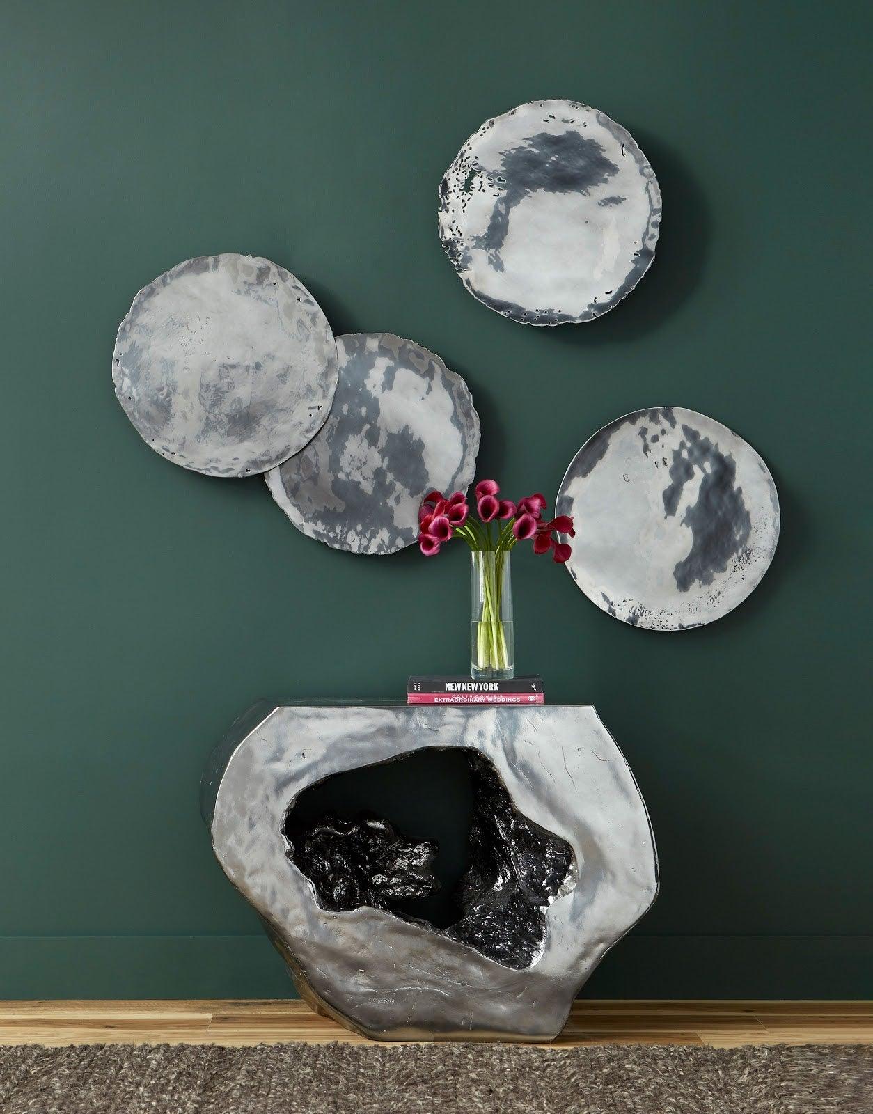 Set of four Liquid Silver Cast Oil Drum Wall Discs, showcasing a rustic design with a liquid silver finish, perfect for modern decor.