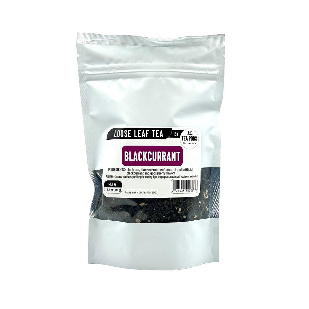 A close-up of Loose Leaf Blackcurrant Black Tea with blackcurrant leaves and tea leaves, showcasing its rich color and texture.