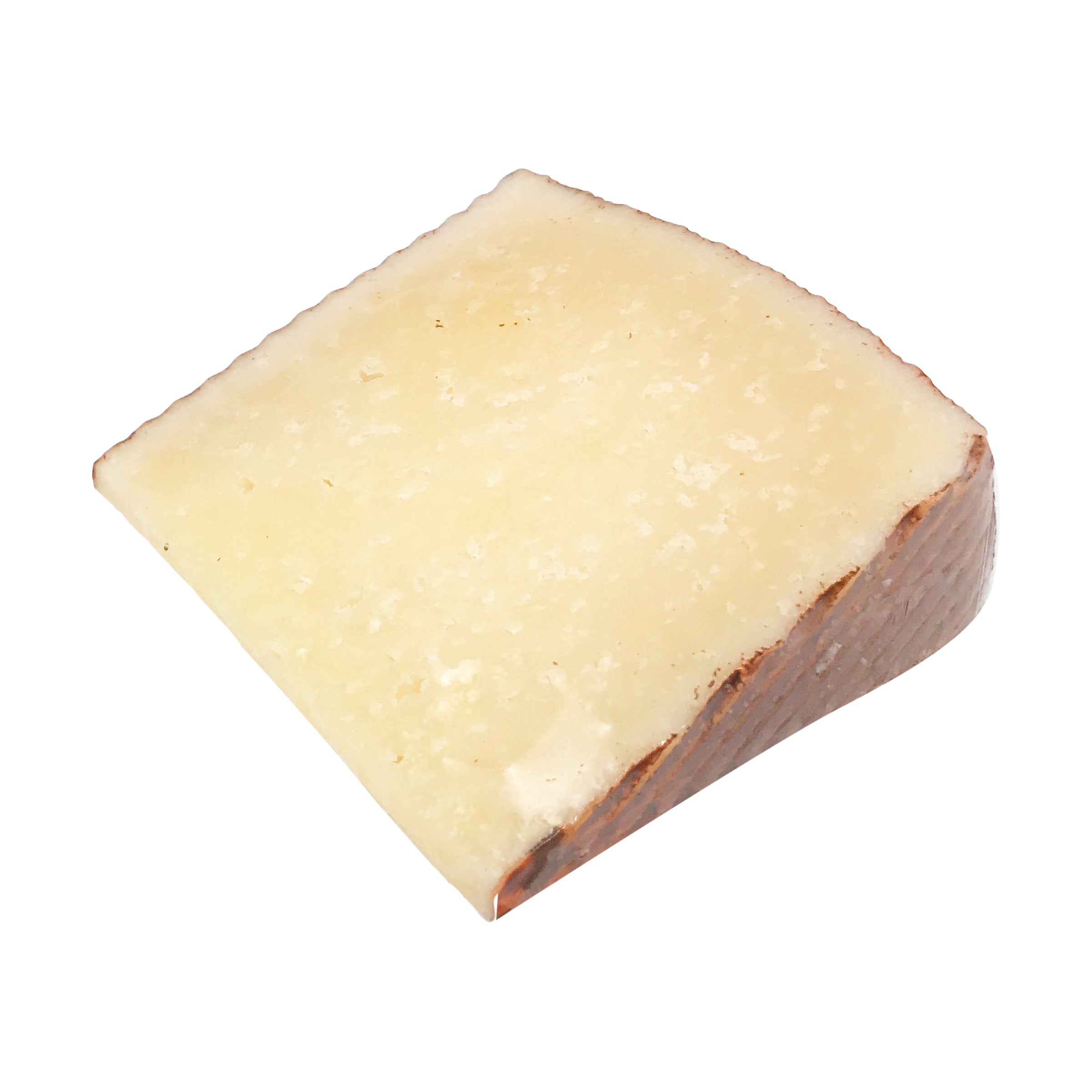 A wedge of Manchego cheese with a zigzag patterned rind, showcasing its creamy texture and straw color.