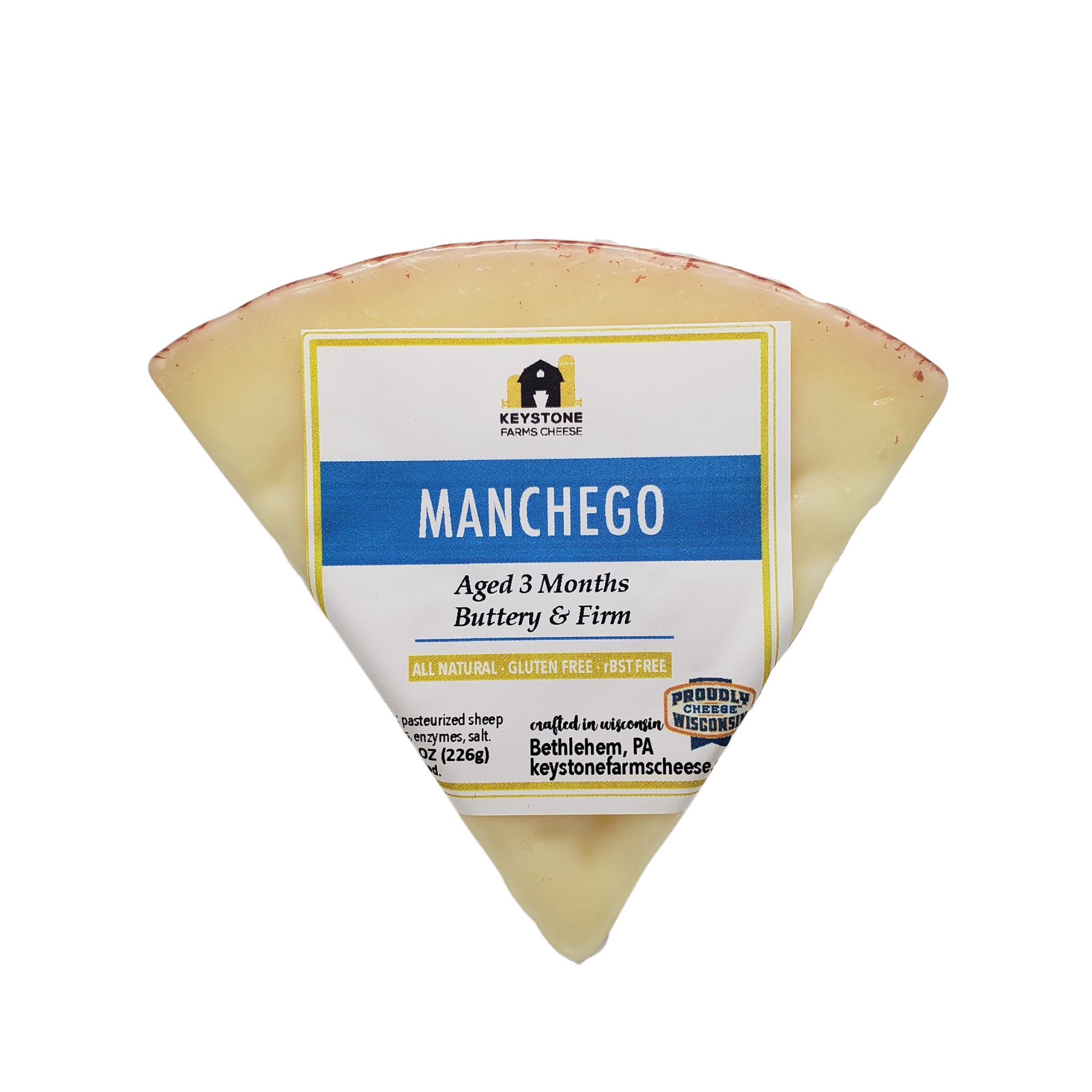 A wedge of Manchego cheese with a zigzag patterned rind, showcasing its creamy texture and straw color.