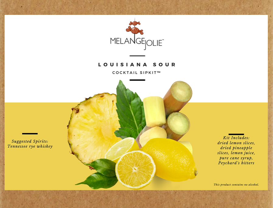 Mélange Jolie Louisiana Sour Cocktail SipKit™ with ingredients and tools for making cocktails, including a rocks glass, bar spoon, and fresh mint.