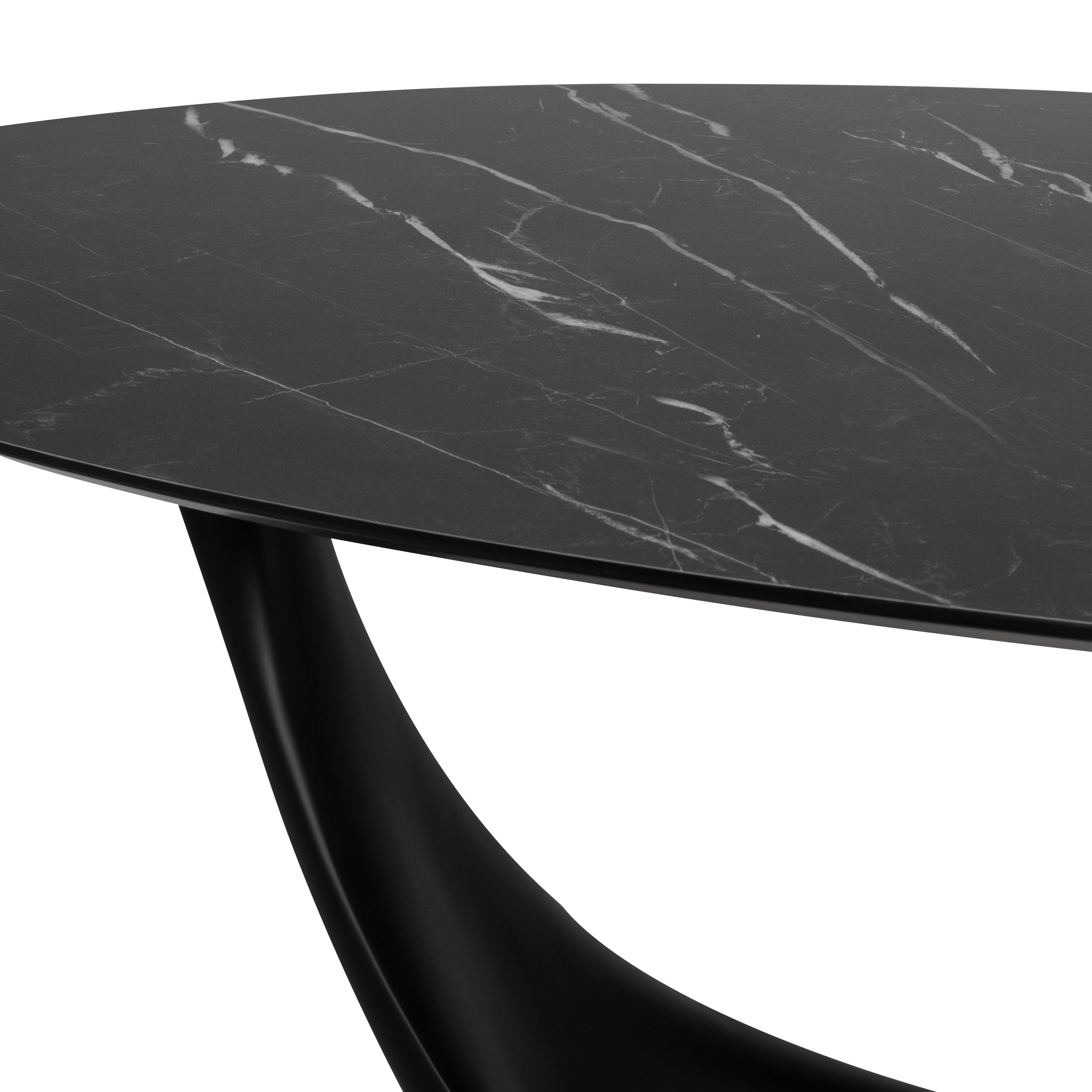 Montana Dining Table in Black with a sculptural base and ceramic oval top, showcasing its elegant design and spacious dimensions.