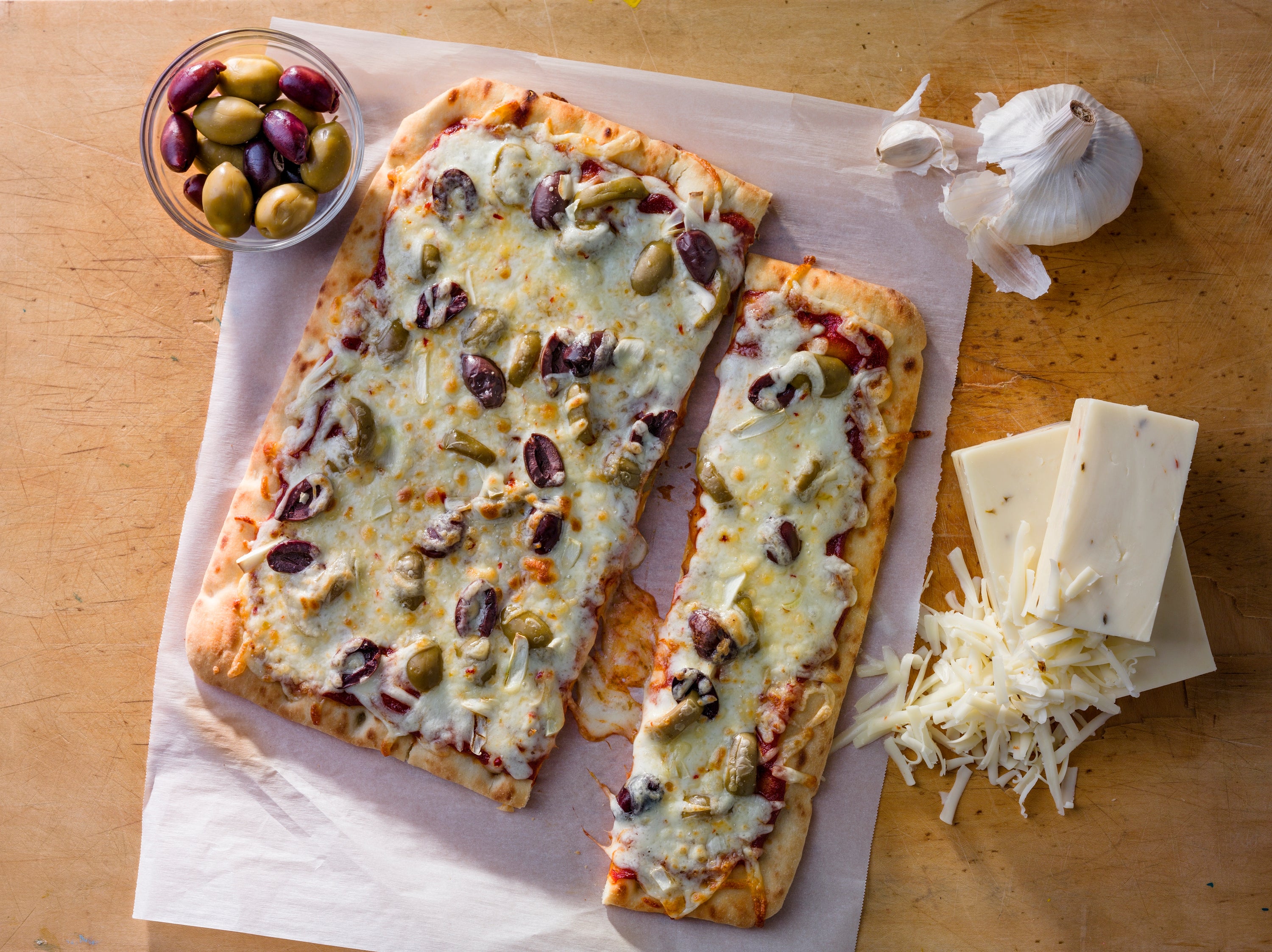 Fresh mozzarella cheese displayed on a wooden board, showcasing its smooth texture and creamy appearance.