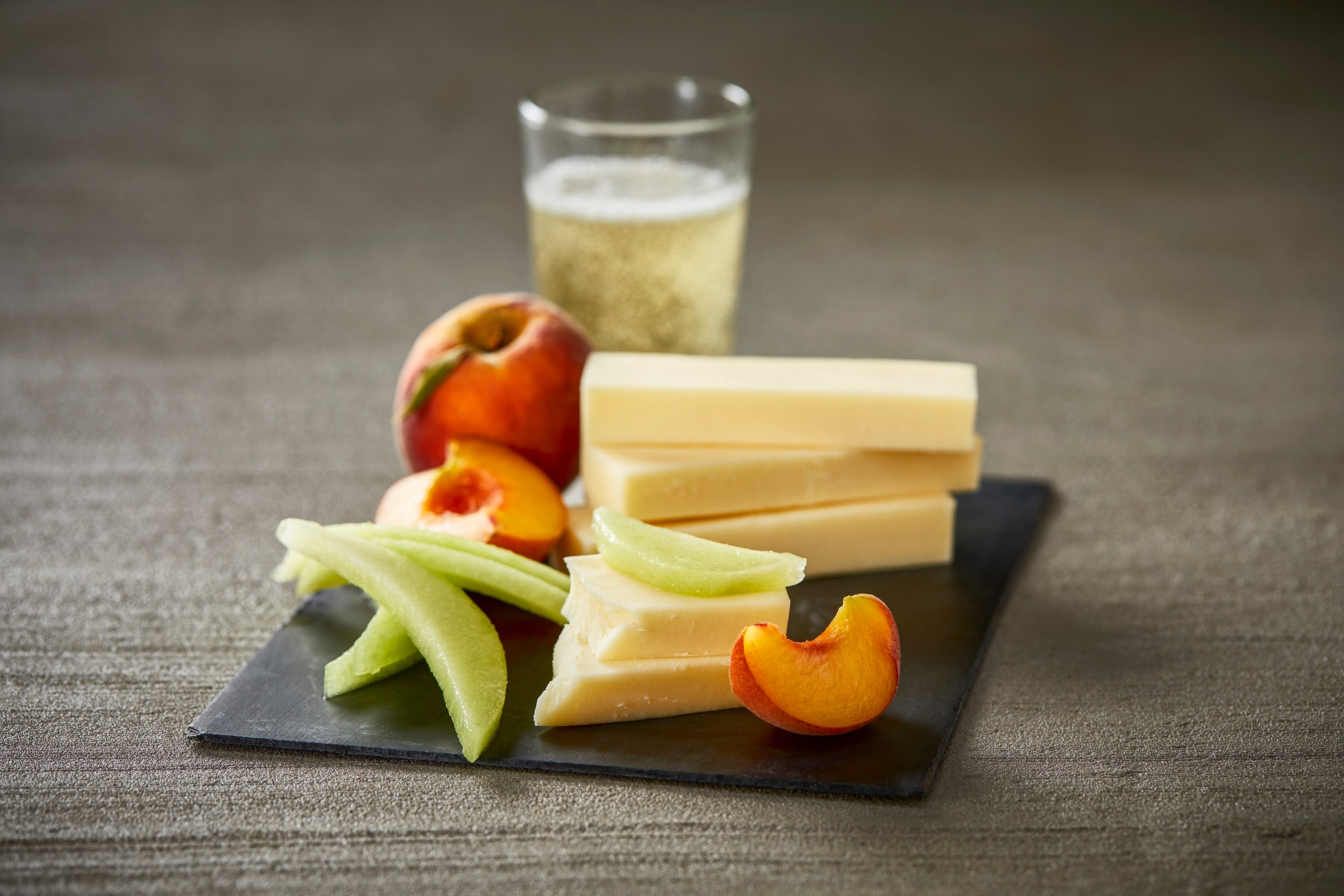 Fresh mozzarella cheese displayed on a wooden board, showcasing its smooth texture and creamy appearance.