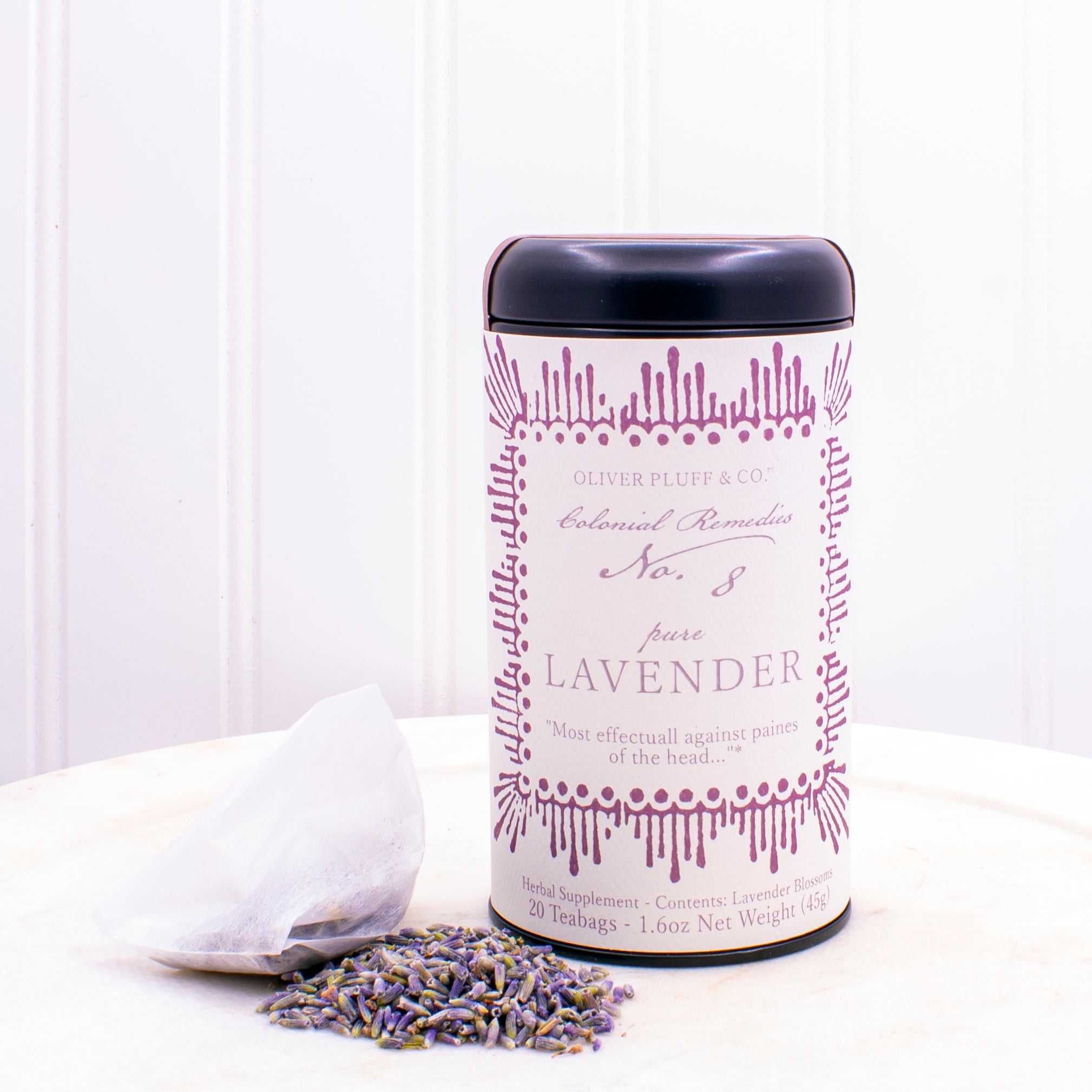 A matte black tin containing 20 biodegradable teabags of No. 8 Pure Lavender tea, showcasing lavender blossoms.